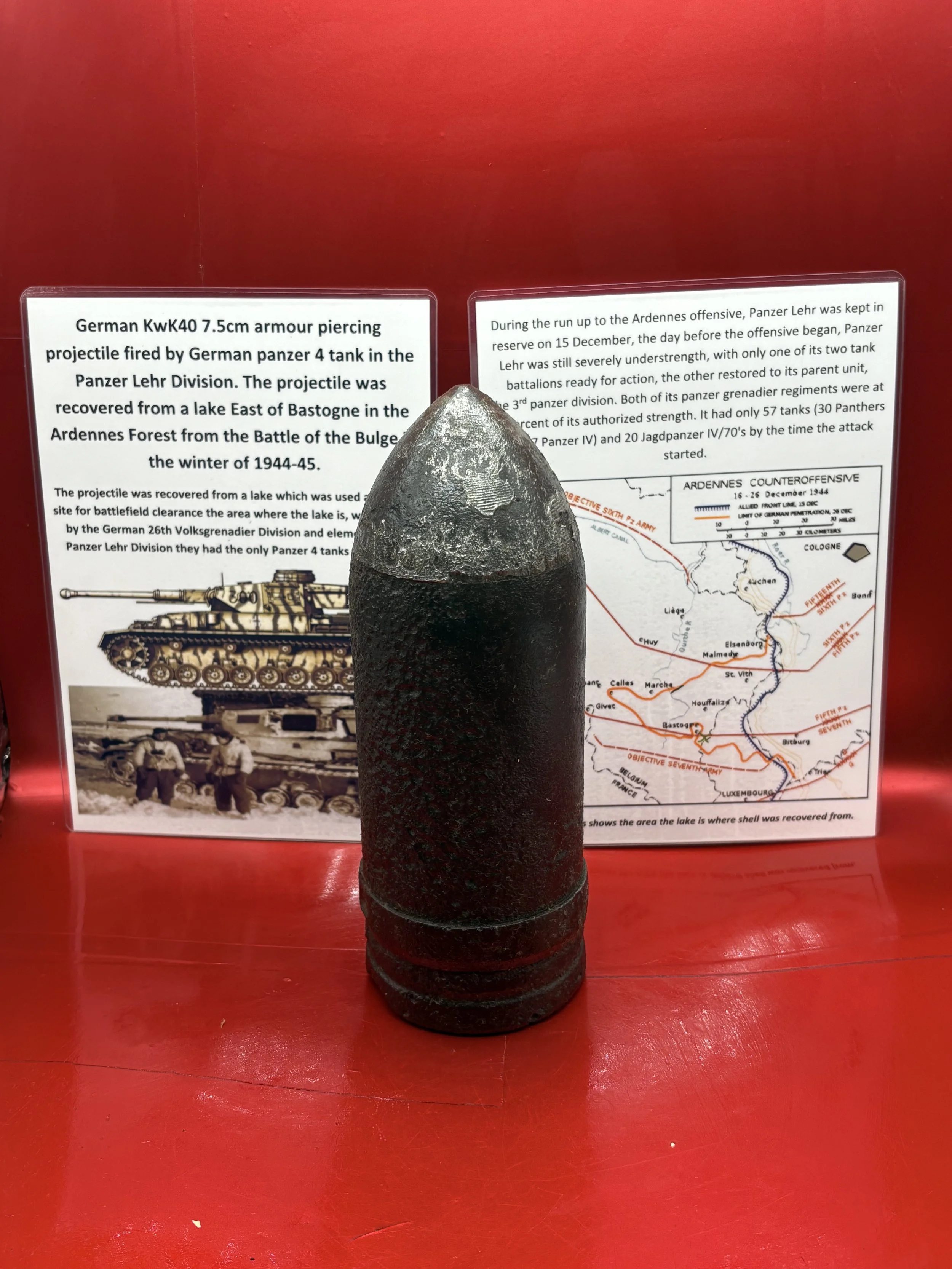 German KwK40 7.5cm armour piercing projectile with complete driving band,markings fired by German panzer 4 tank, it was recovered from a lake East of Bastogne in the Ardennes Forest 1944-1945