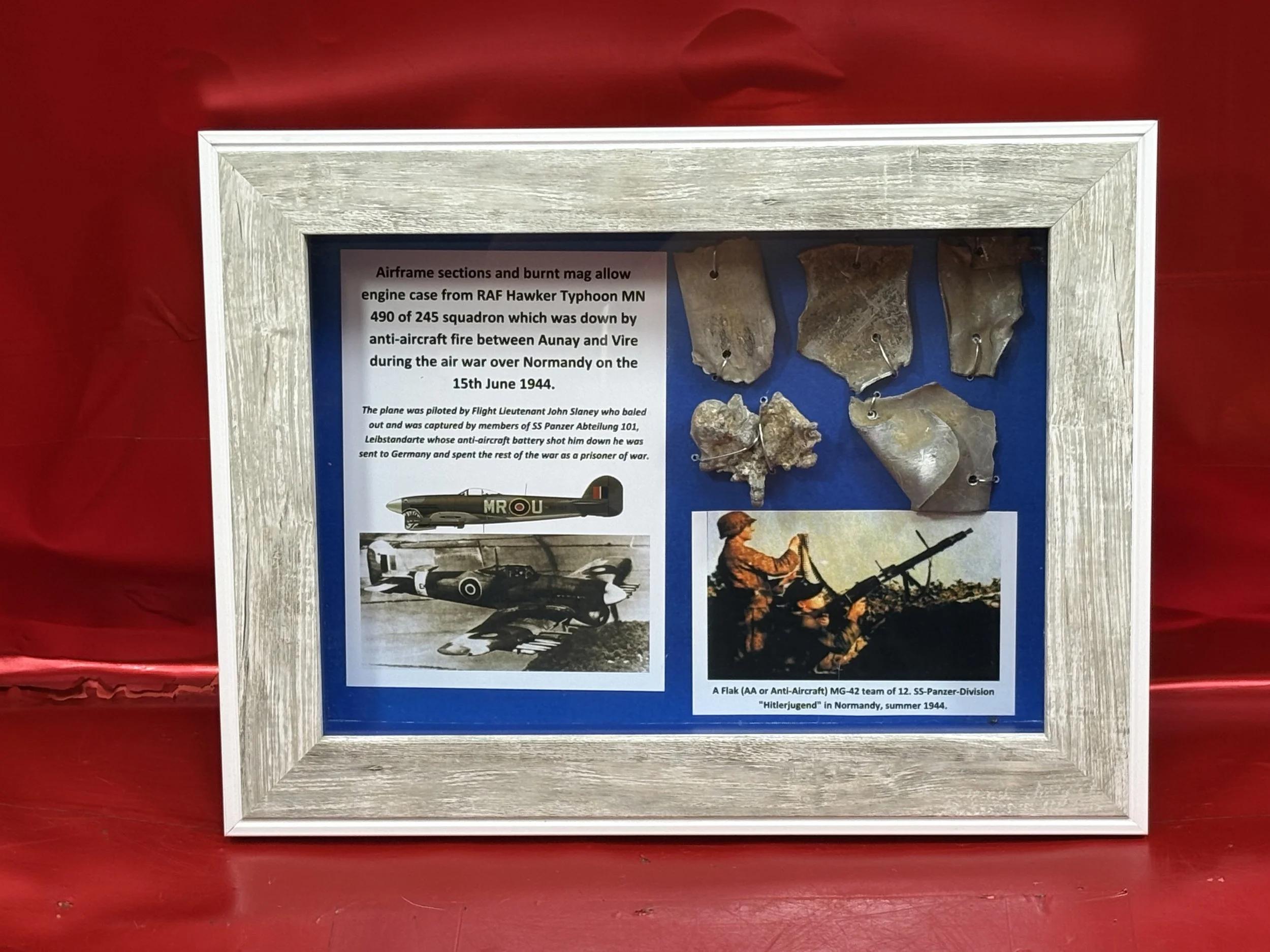 Glass framed airframe sections/mag allow engine case from RAF Hawker Typhoon MN 490 of 245 squadron,shot down by anti-aircraft fire during the air war over Normandy on 15th june 1944