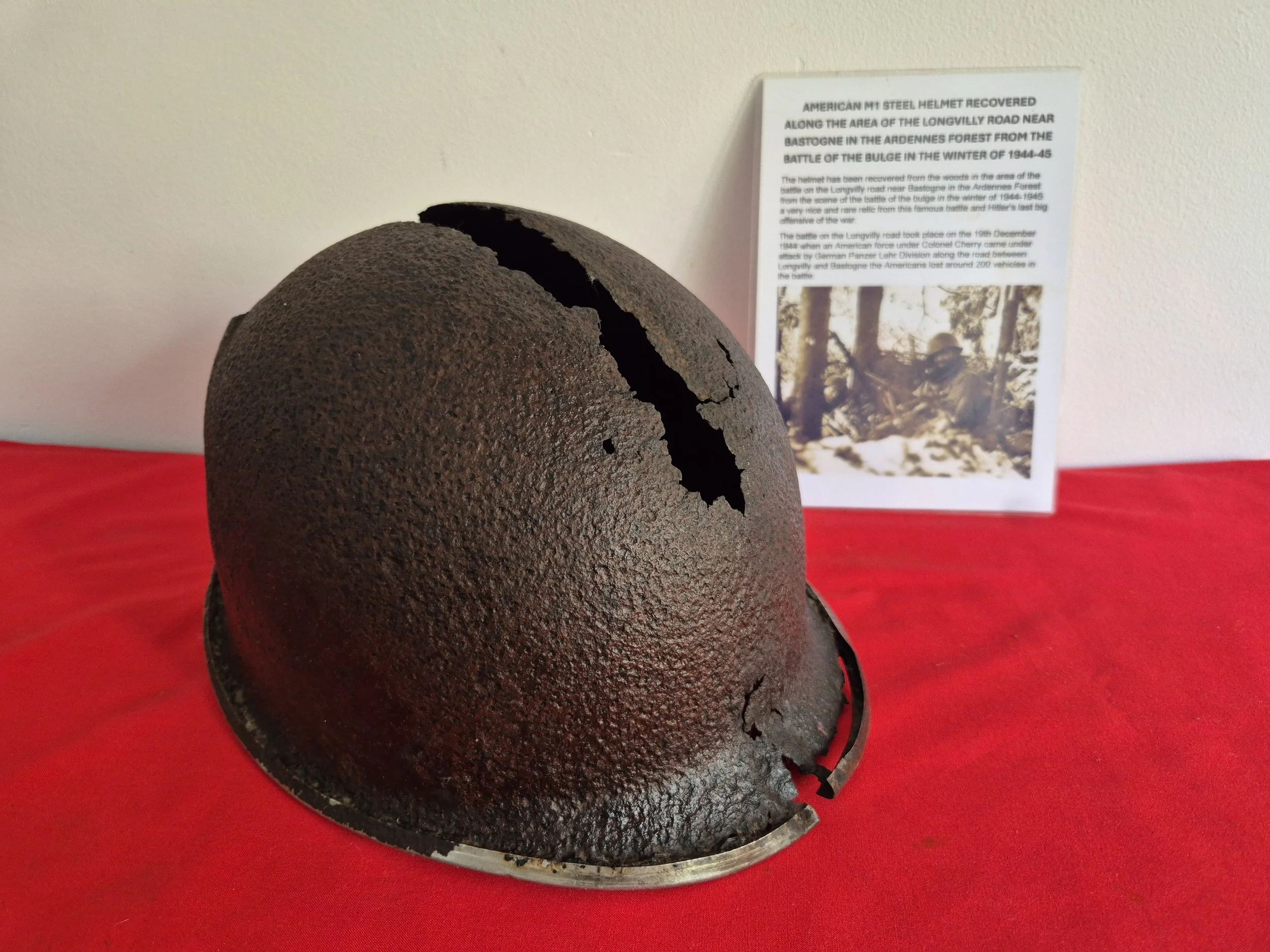 AMERICAN M1 STEEL HELMET RECOVERED ALONG THE AREA OF THE LONGVILLY ROAD NEAR BASTOGNE IN THE ARDENNES FOREST FROM THE BATTLE OF THE BULGE IN THE WINTER OF 1944-45