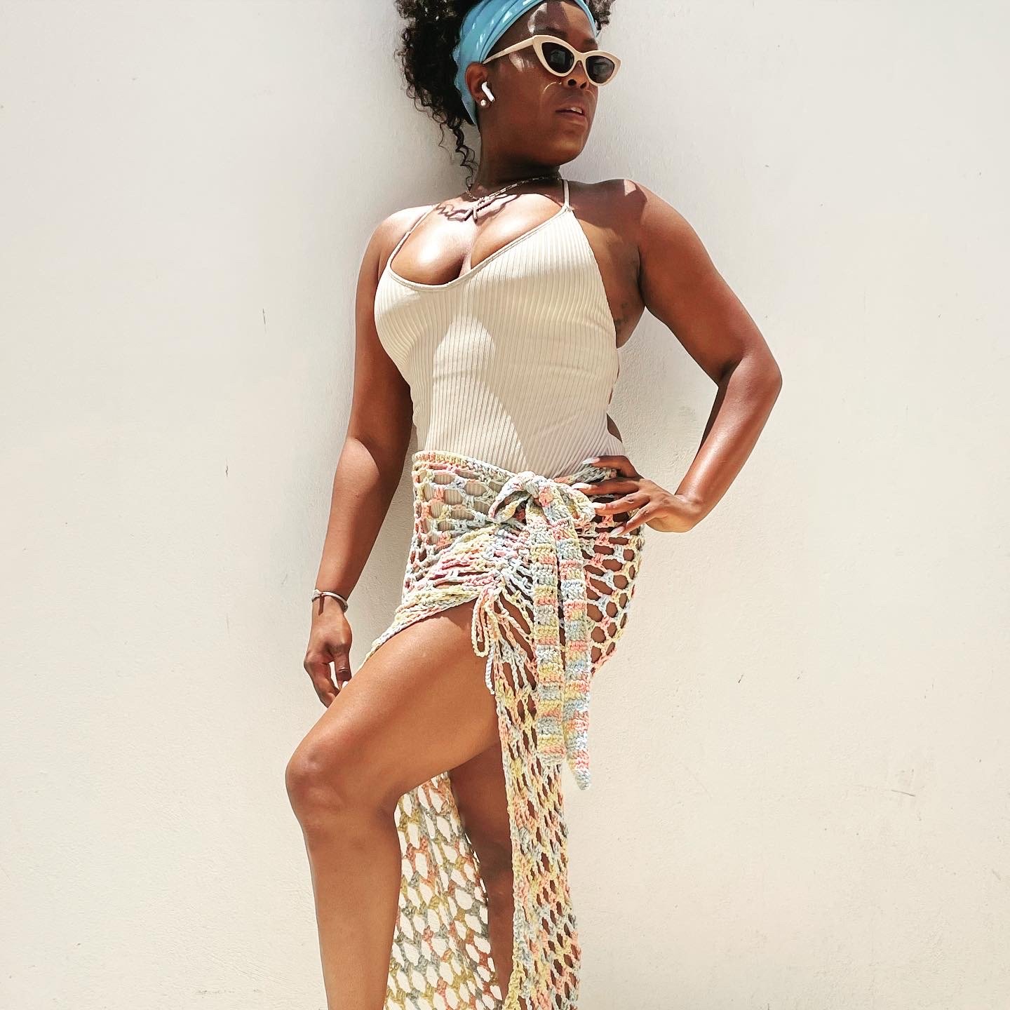 KC Carnage wearing a beige top and multicolored crochet skirt, embodying elevated travel style and modern luxury with Legacy Reserve Travel.