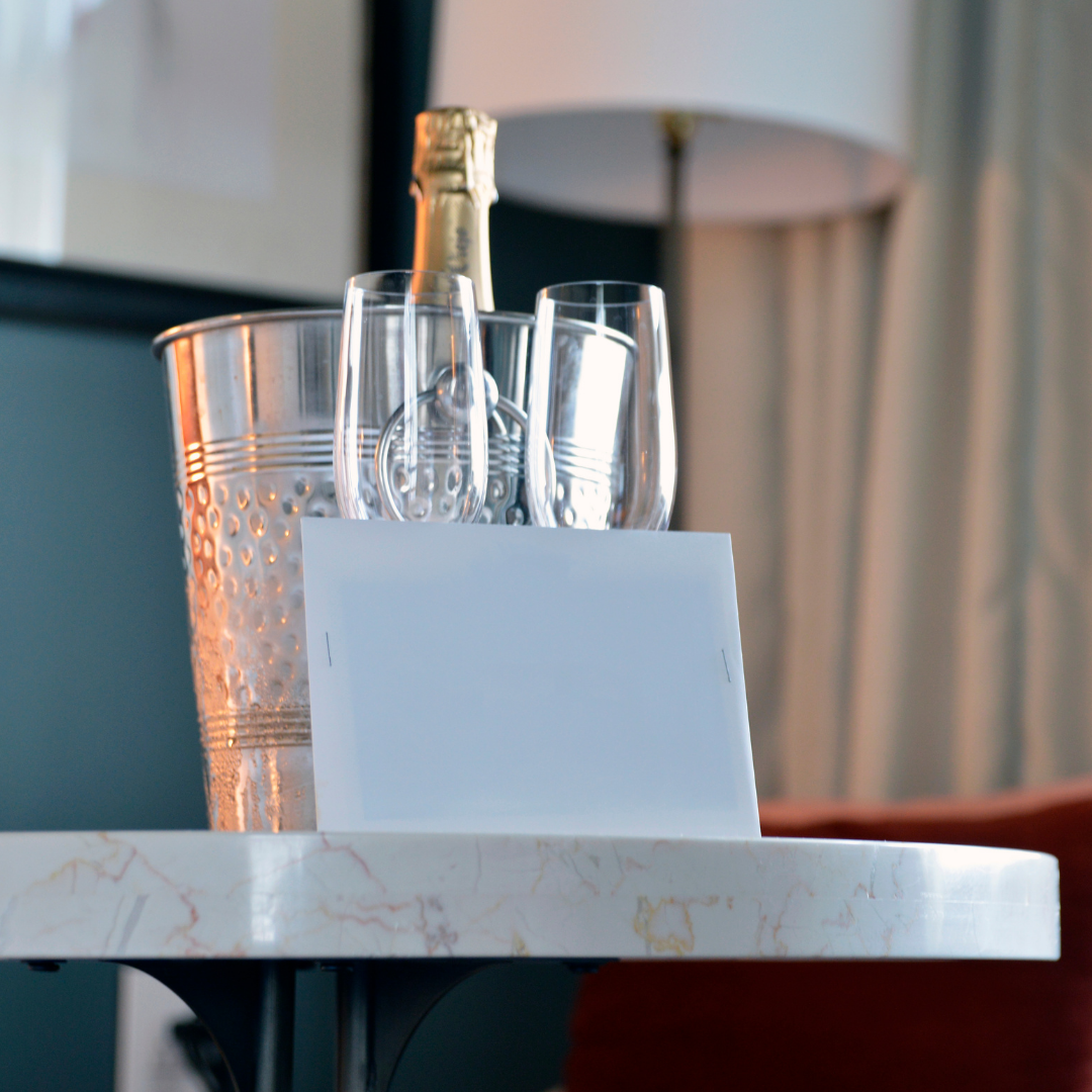 Champagne on ice with elegant glassware and soft lighting, evoking the sophistication of Legacy Reserve Travel’s curated luxury stays.