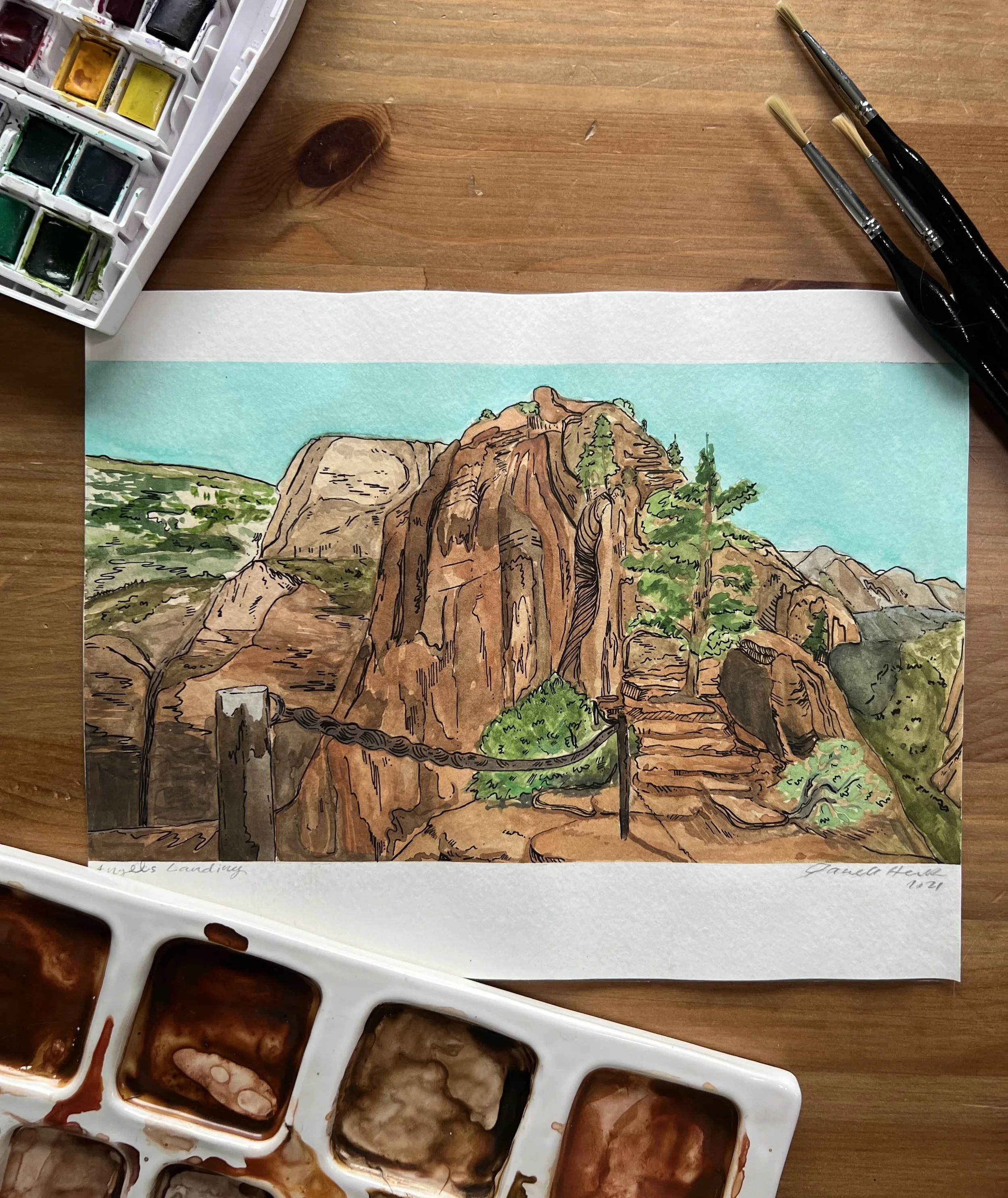 A watercolor painting of a rocky landscape with hiking stairs, trees, and a bright blue sky, created with watercolor paints and brushes.