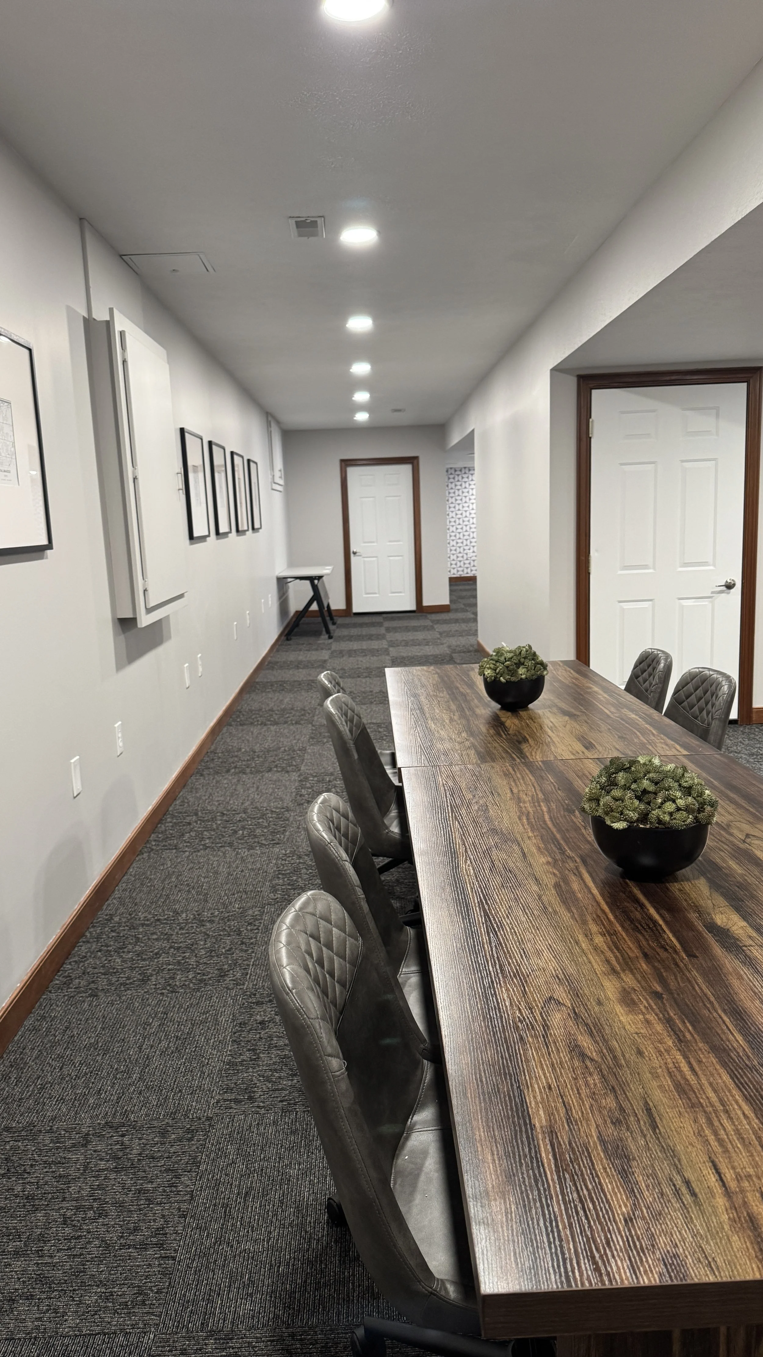 After Photo - Hallway after remodel with new can lights, paint, carpet, decorations