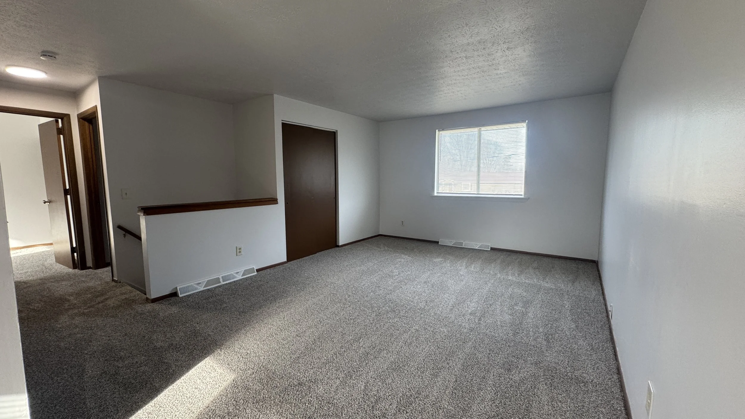 After Photo - Living room in canton ohio with new paint, carpet and painted doors