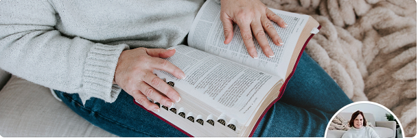 kim vanderpoel reading the bible with a blanket next to her