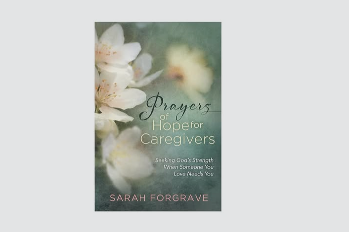 Book cover titled "Prayers of Hope for Caregivers" by Sarah Forgrave, featuring soft white flowers on a blurred green background.