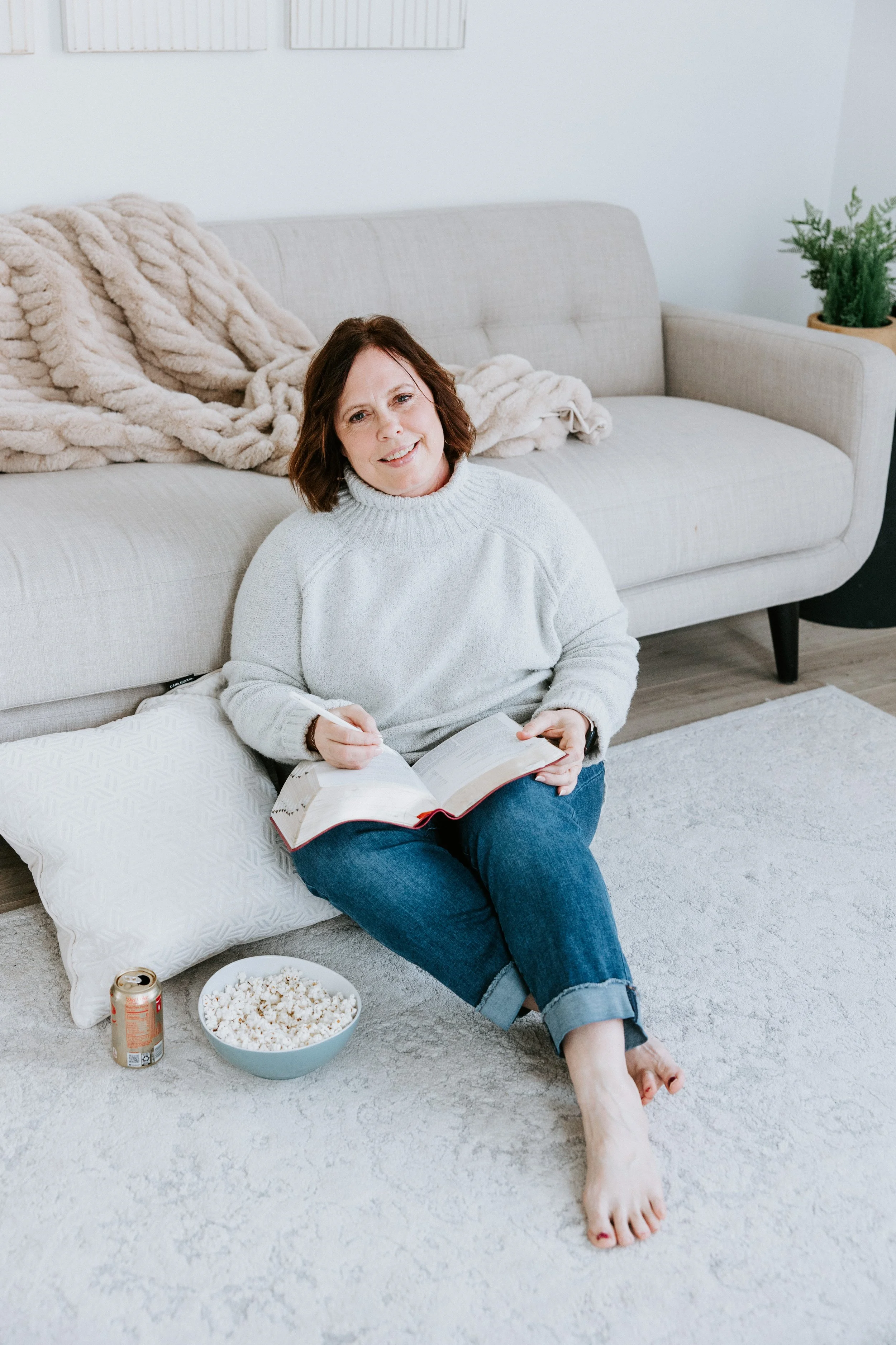kim vanderpoel sitting on the floor with a pillow and her bible, popcorn