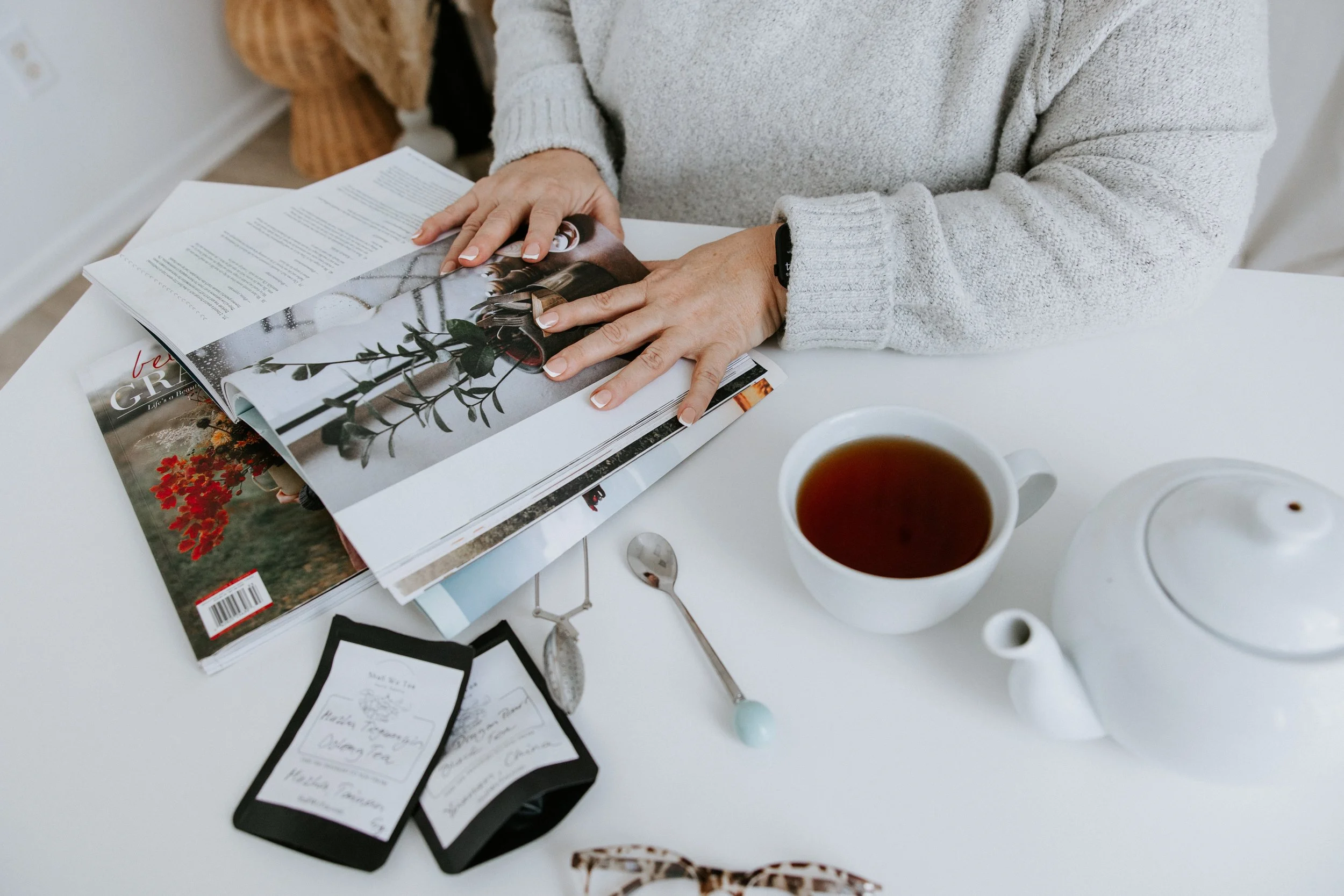 Kim Vander Poel reading a magazine and drinking tea