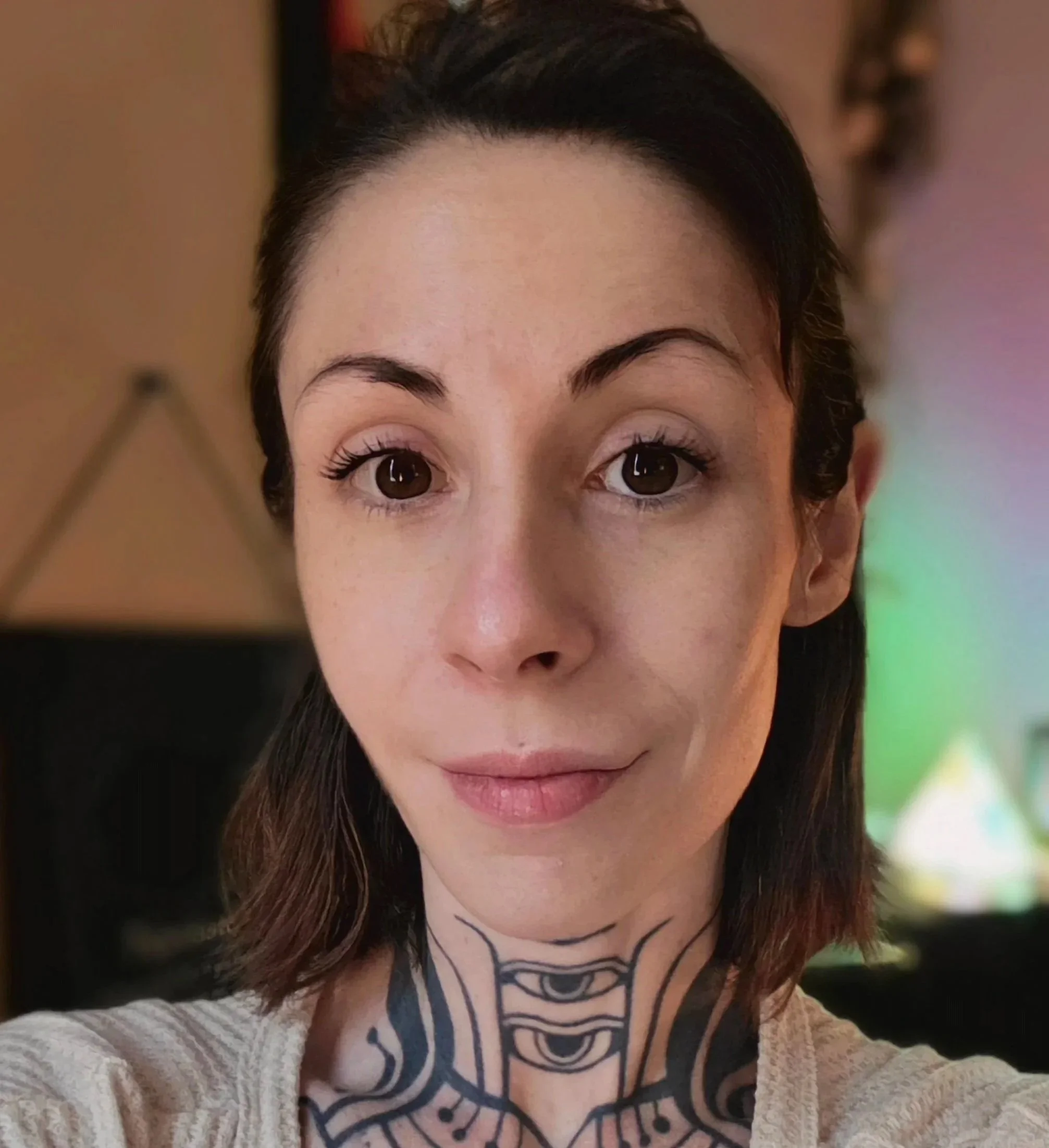 Headshot of Rose Pesca, LMT, a massage therapist specializing in somatoemotional release, craniosacral massage, lymphatic drainage, Swedish massage, and somatic treatments for trauma.