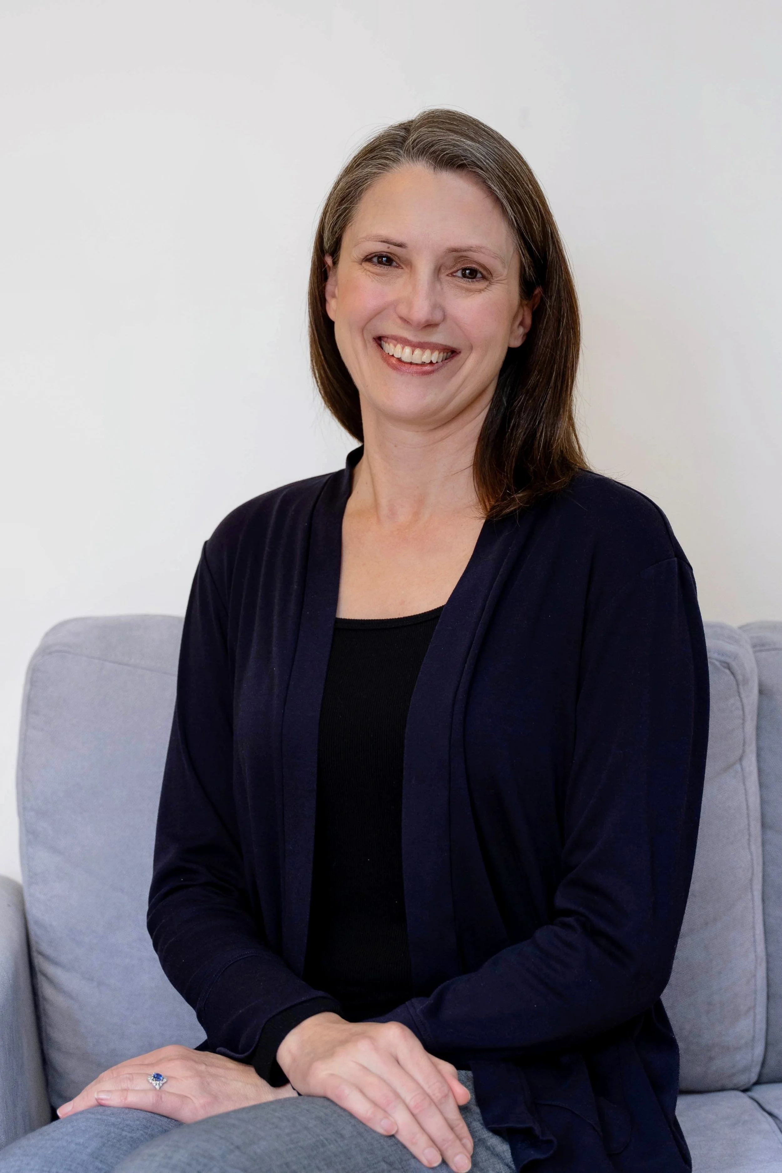 Headshot of April McKee, LPC‑S, a disability‑affirming and neuroaffirmative therapist specializing in counseling adults with disabilities and LGBTQ+ clients.