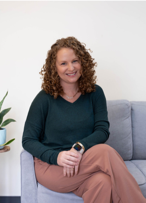 Audrey Smith, ALC, a neuroaffirmative therapist and Perinatal Mental Health Certified provider, photographed in her Tree of Life office. Founder of Grow Our Village.