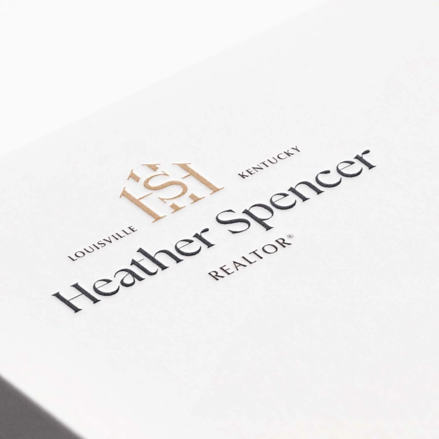 Heather Spencer Realtor logo design embossed on cardstock