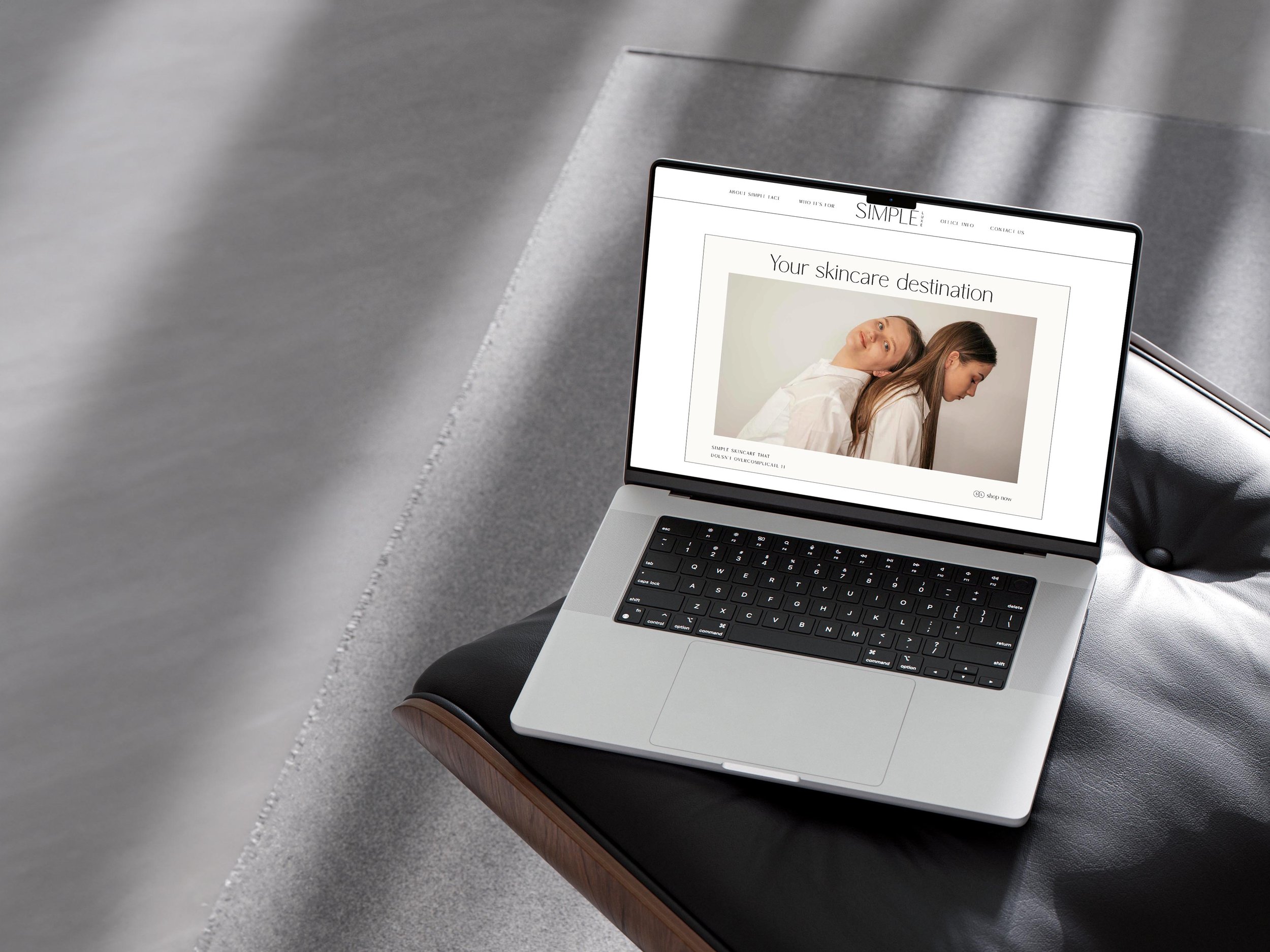 Simple Luxe template homepage, mocked up on a laptop