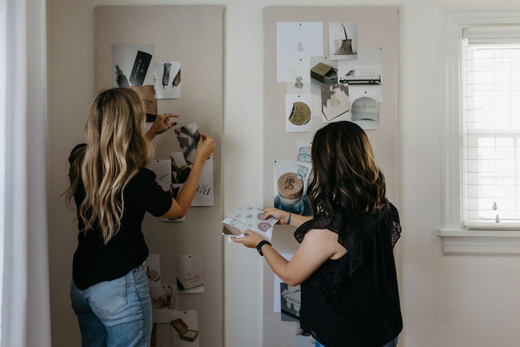 brand designers pinning photos to moodboard