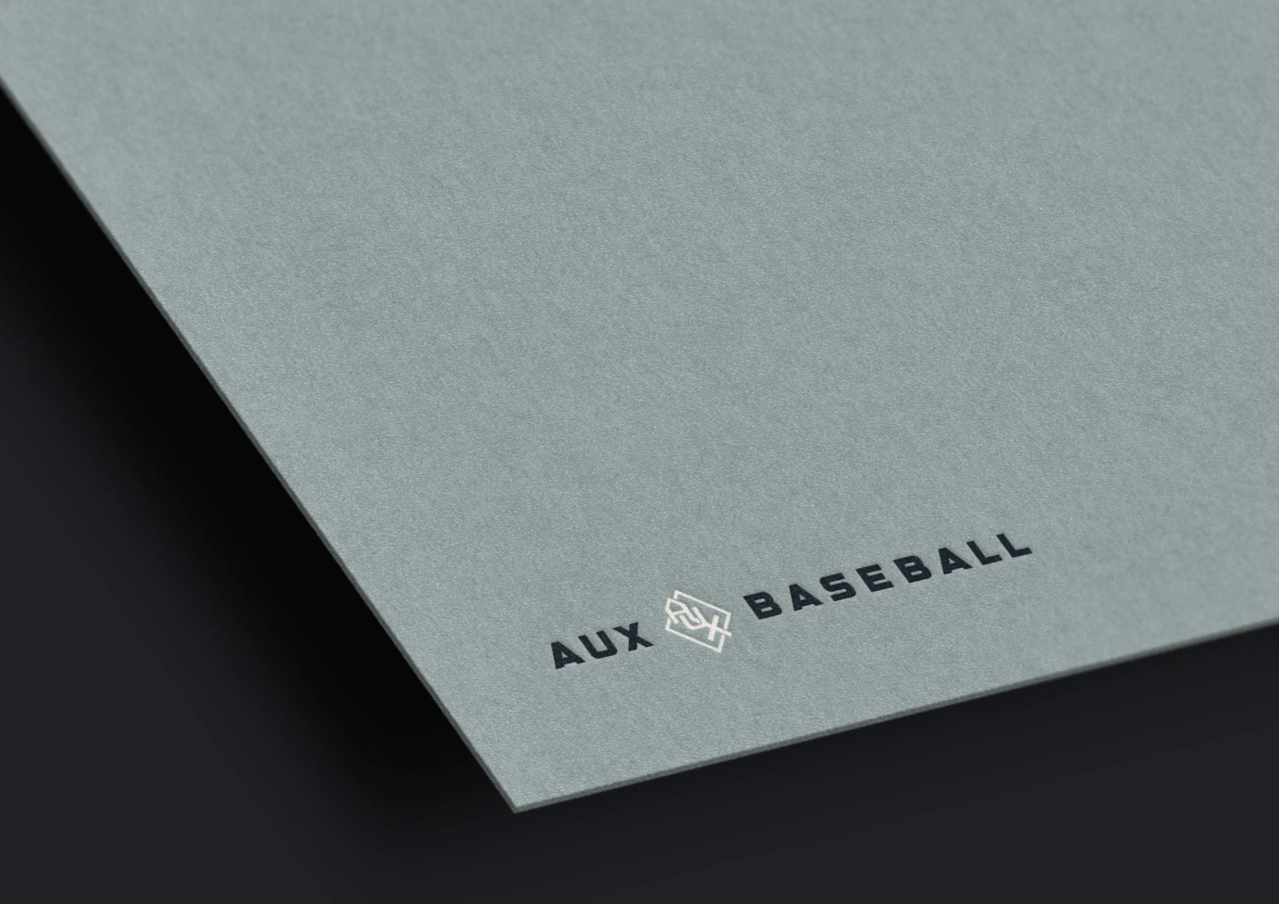 Aux Baseball logo embossed on blue cardstock
