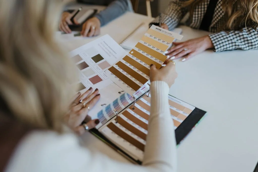 brand designers looking at Pantone color swatches