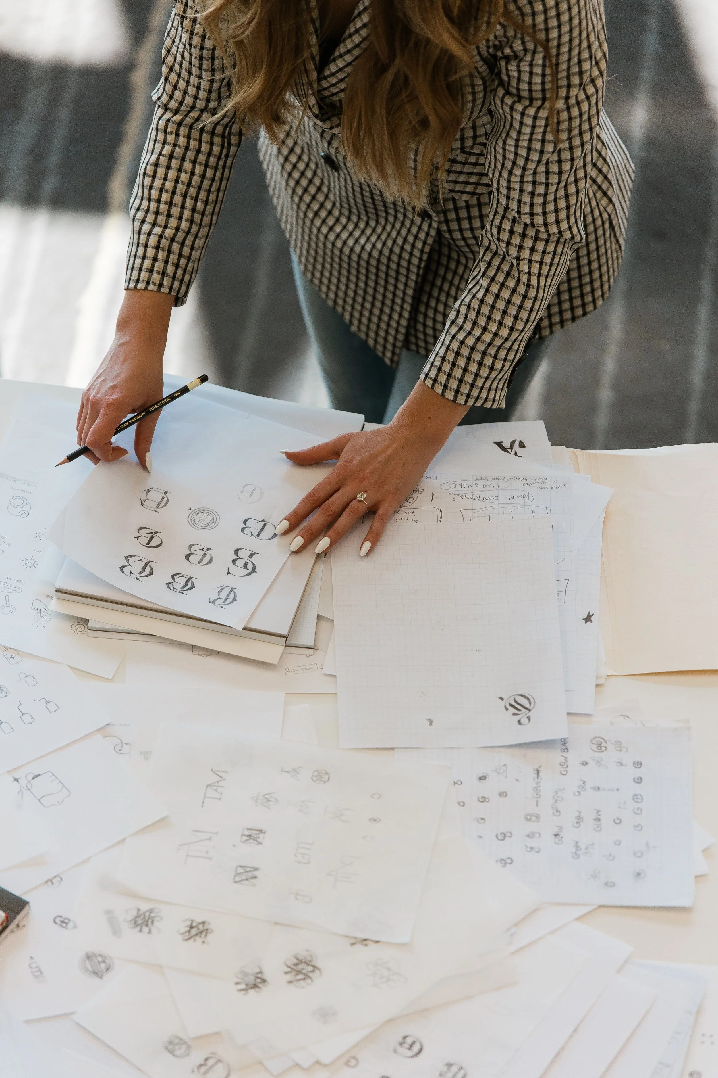 Luxury logo designer Kathryn Joachim with her pencil sketches