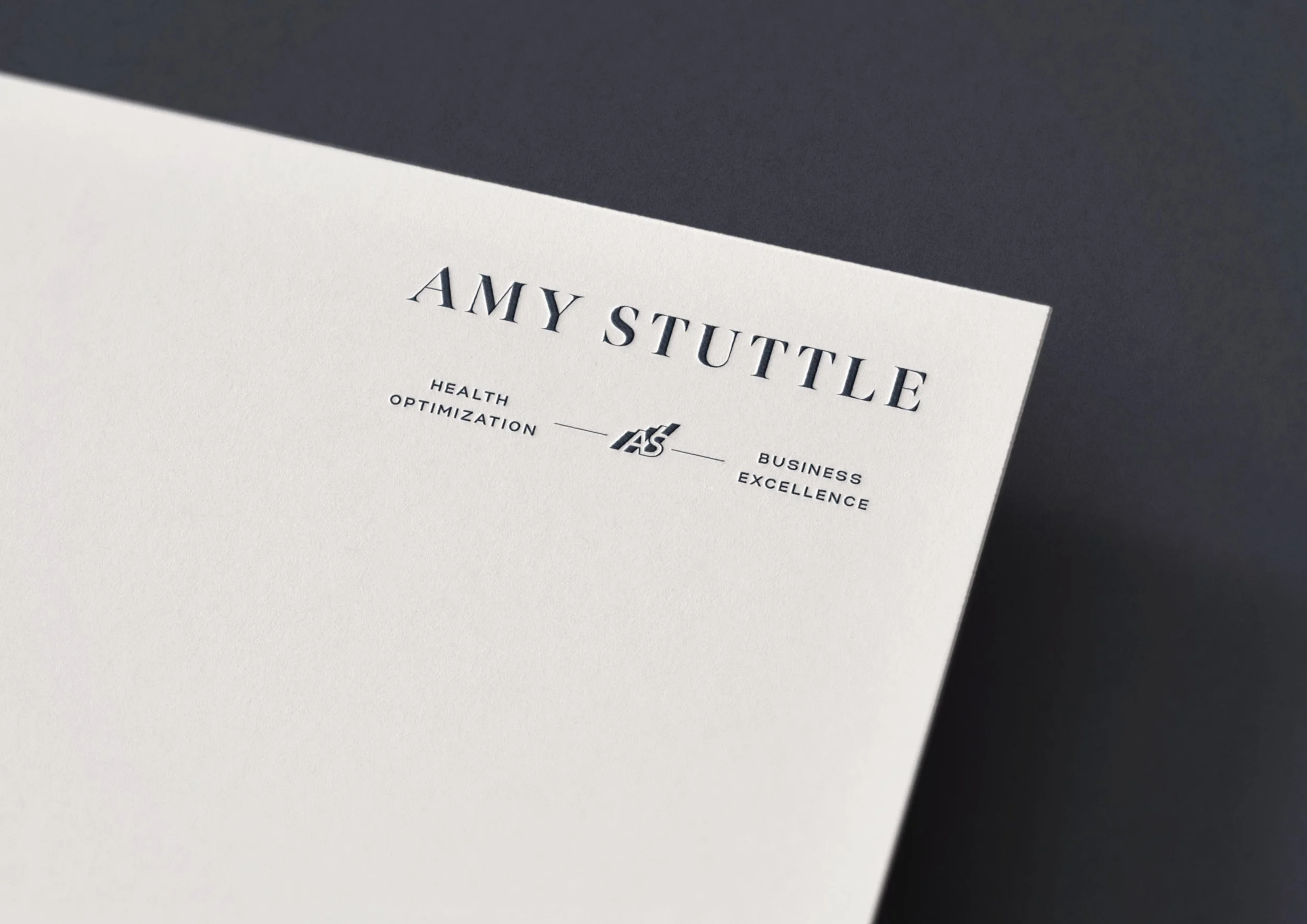 Amy Stuttle Consulting logo embossed on white cardstock