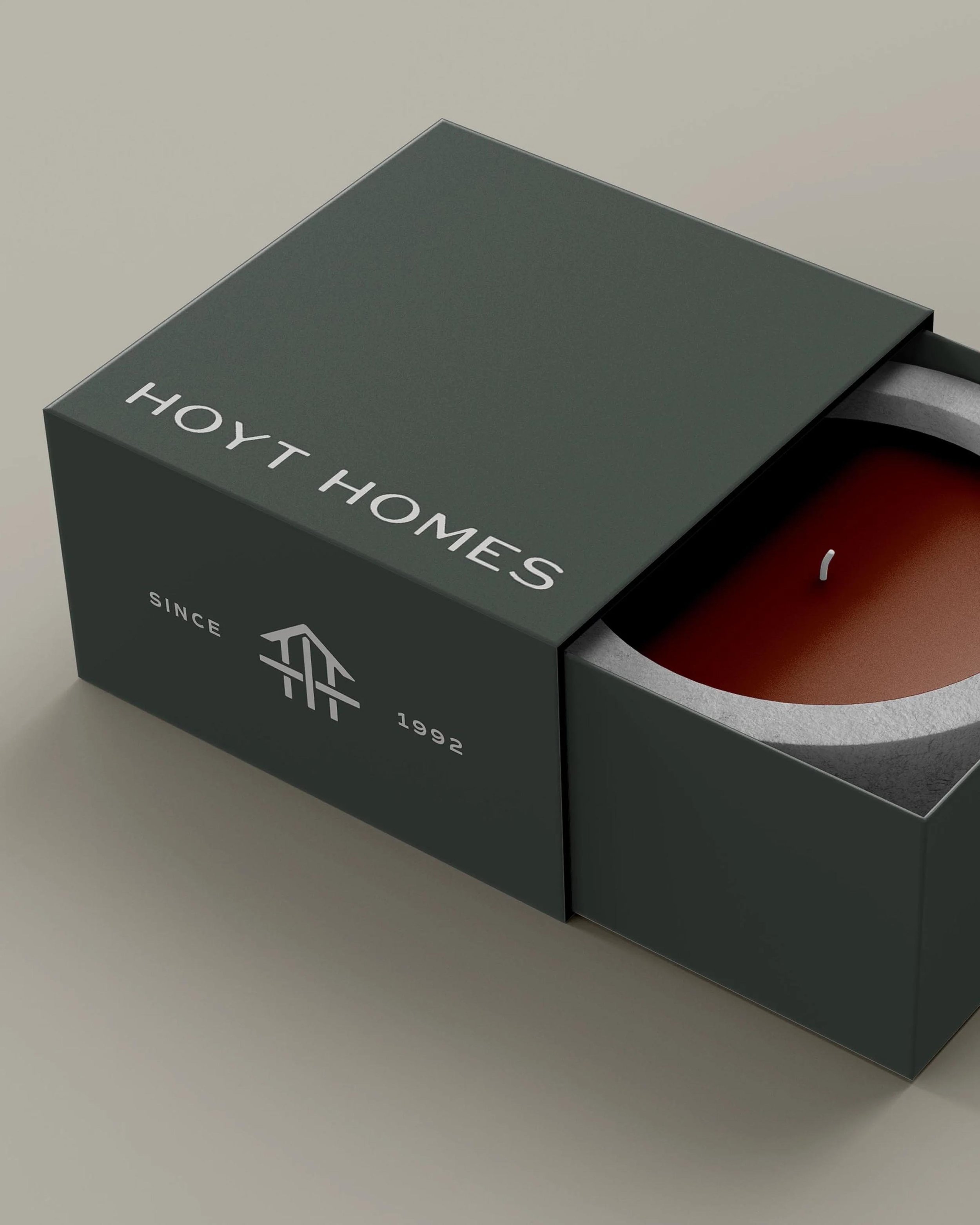 candle in a box printed with the Hoyt Homes logo