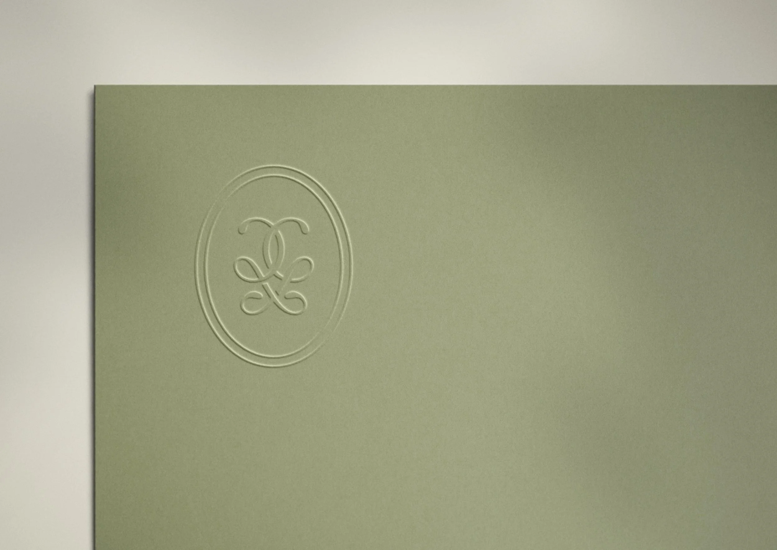 Gather & Glow monogram embossed on green cardstock