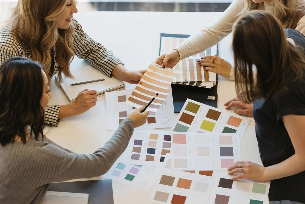 brand designers exchanging Pantone color chips