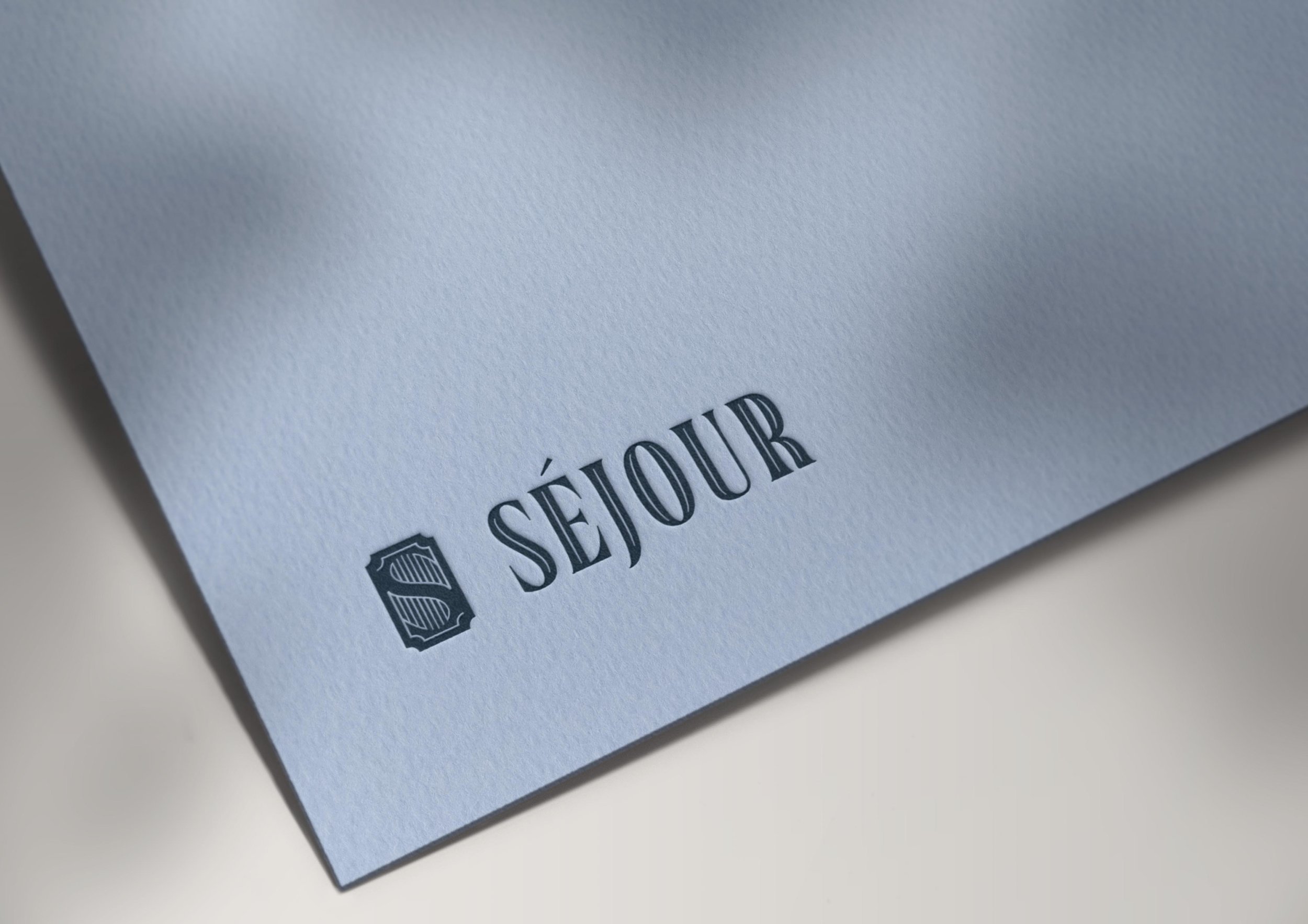 Sejour Events logo embossed on blue cardstock