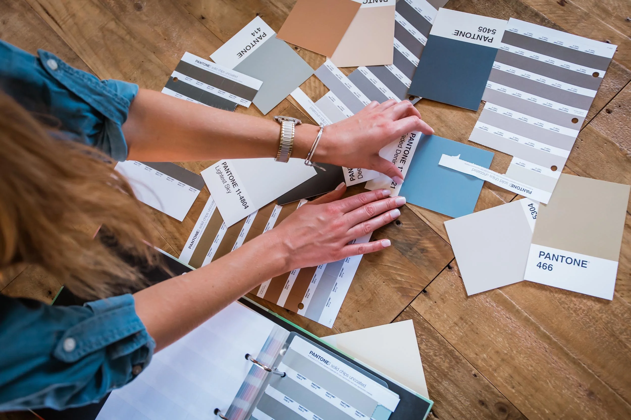 brand designer looking through Pantone swatches