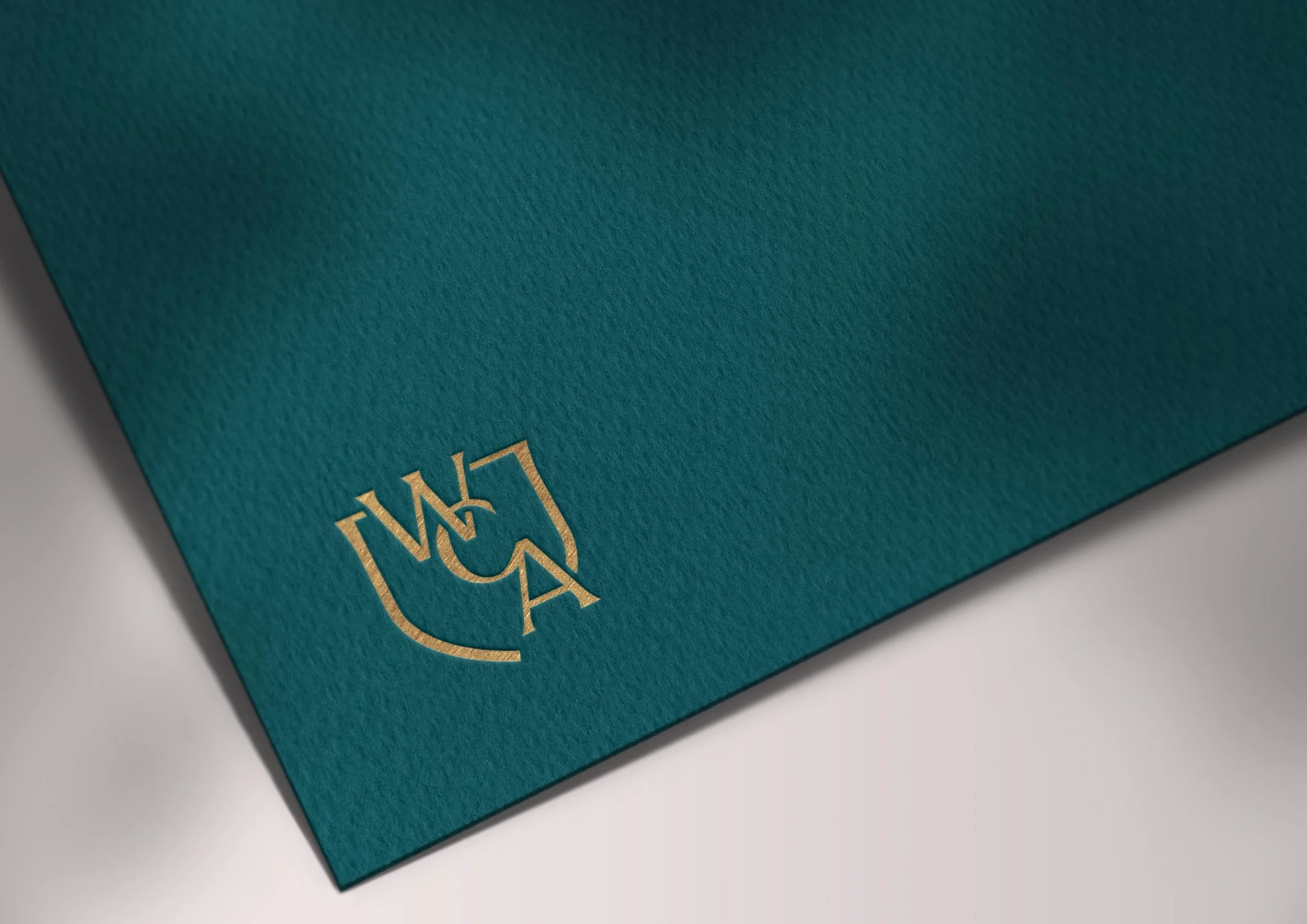 WCA monogram foil printed on teal cardstock