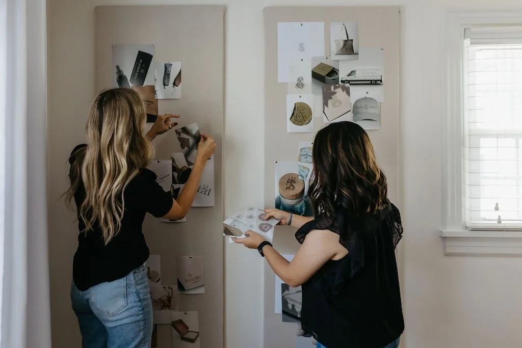 Creme Brands team pinning photos to a moodboard
