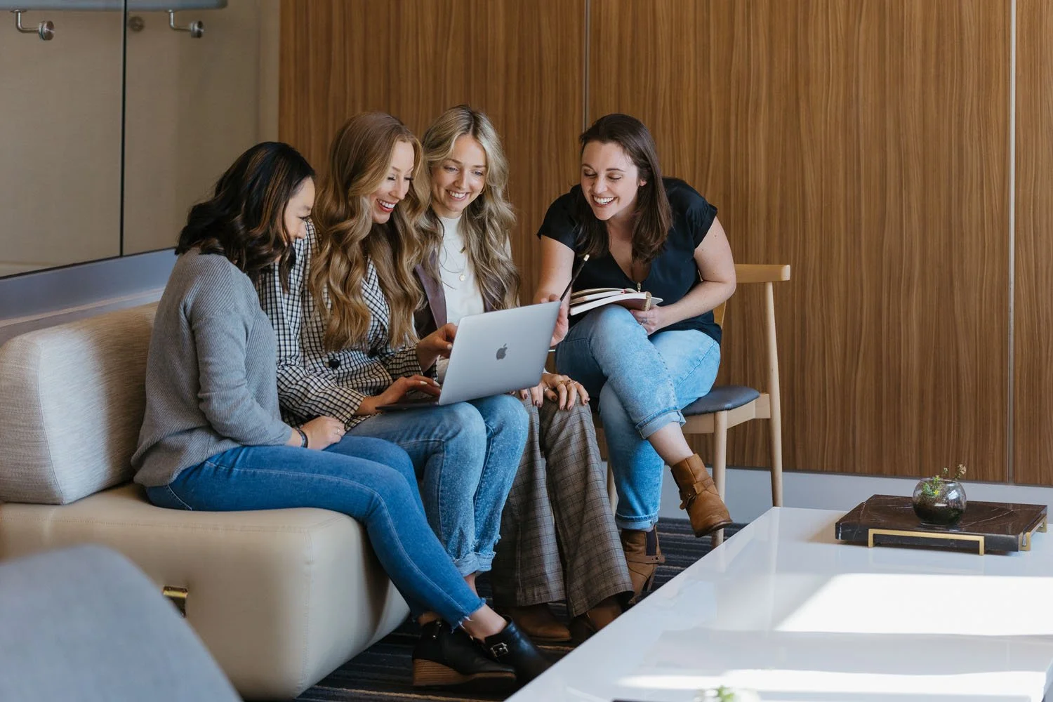Creme Brands team meeting around a laptop