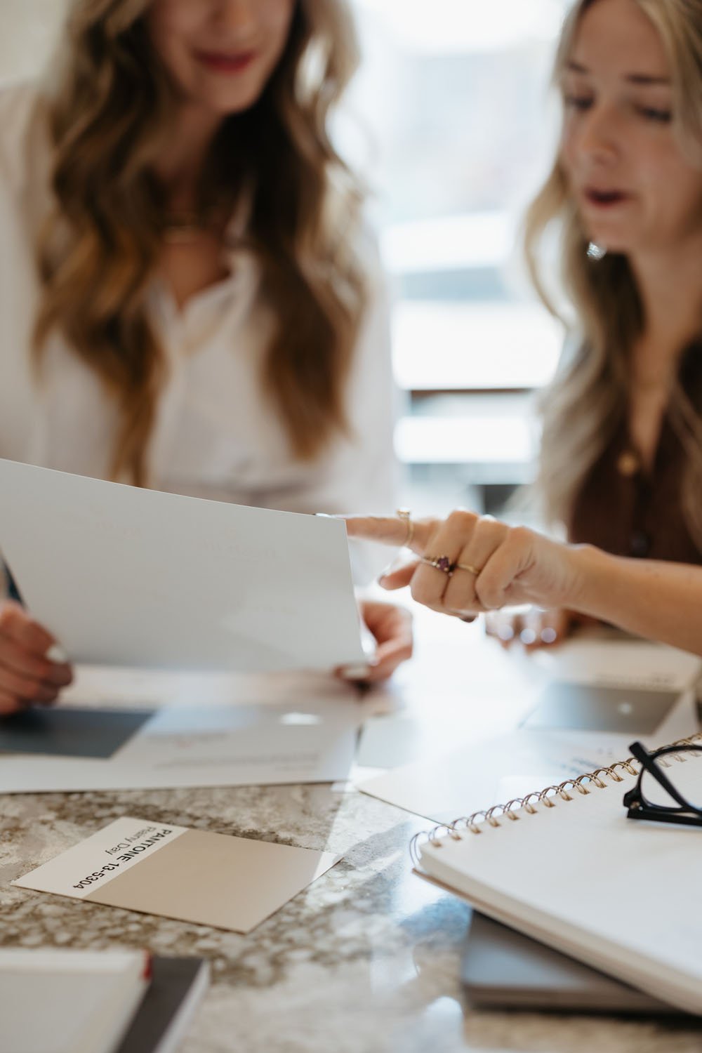 Creme Brands team pointing to logo option