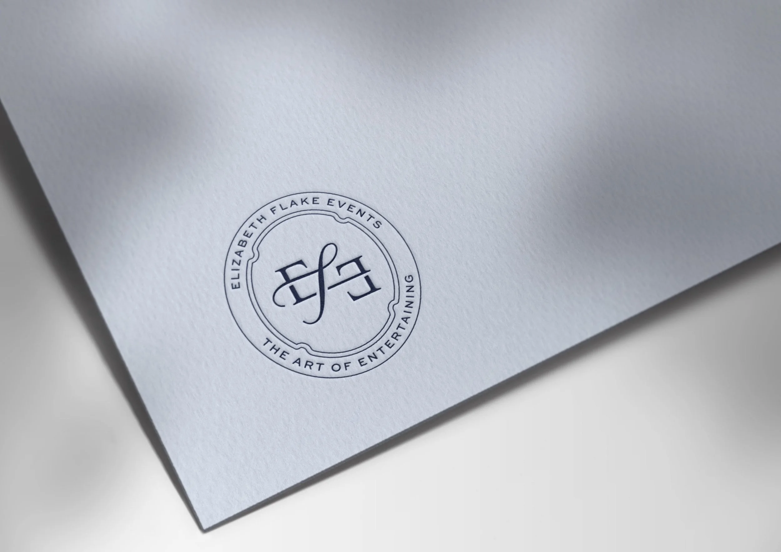 Elizabeth Flake Events logo embossed on light blue card stock