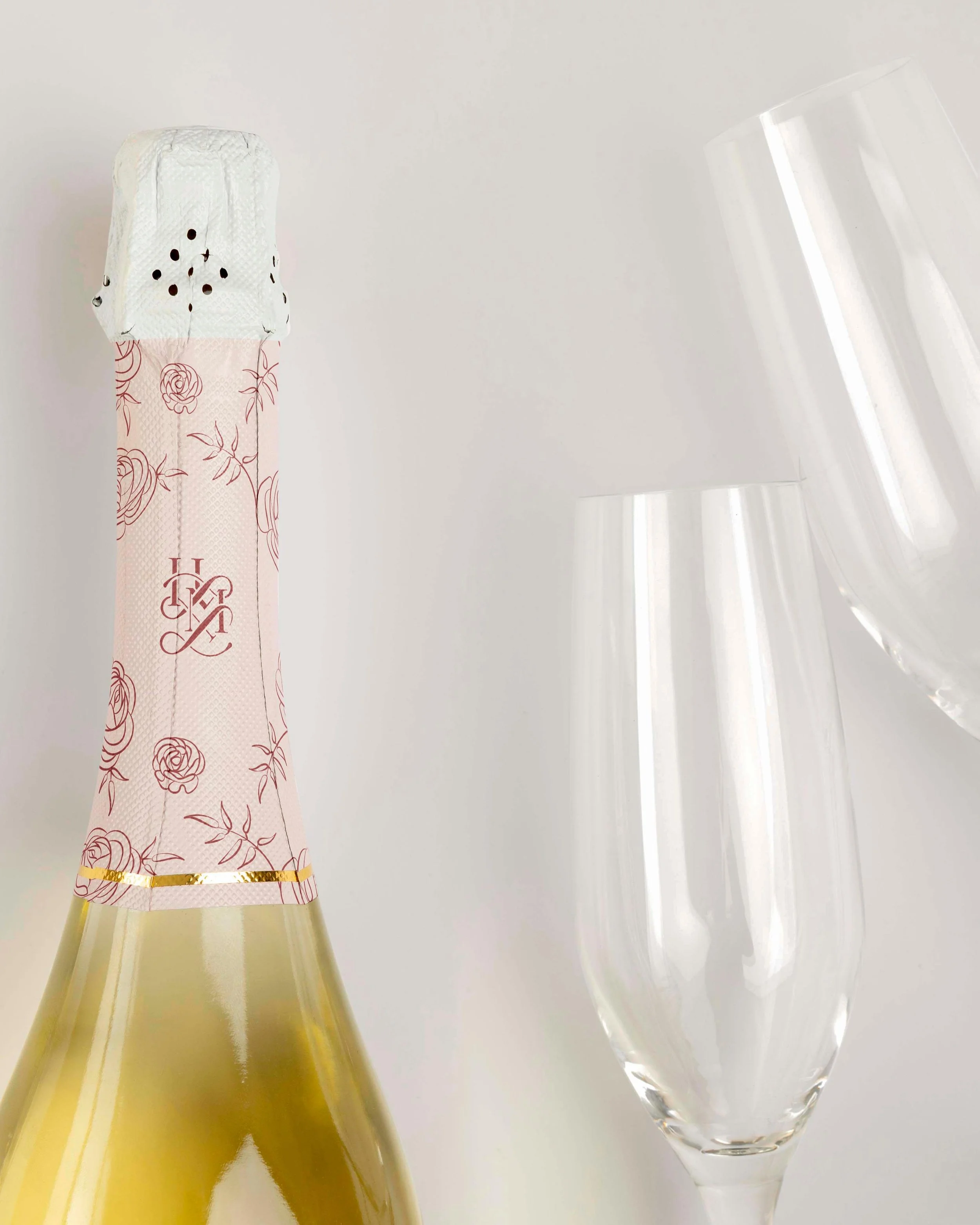 champagne bottle custom printed with the He Loves Me Flowers logo and floral illustrations
