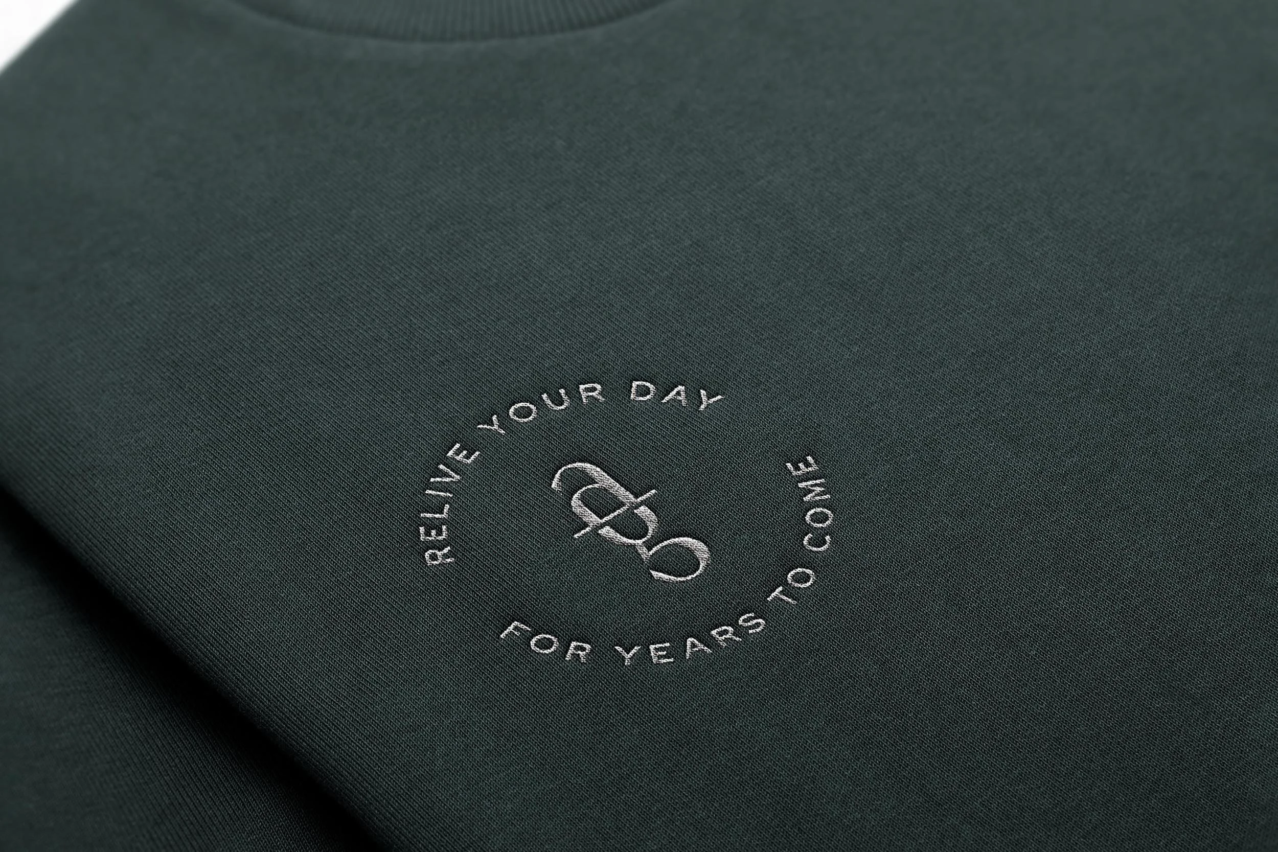 sweatshirt embroidered with "Relive your day/for years to come" tagline badge