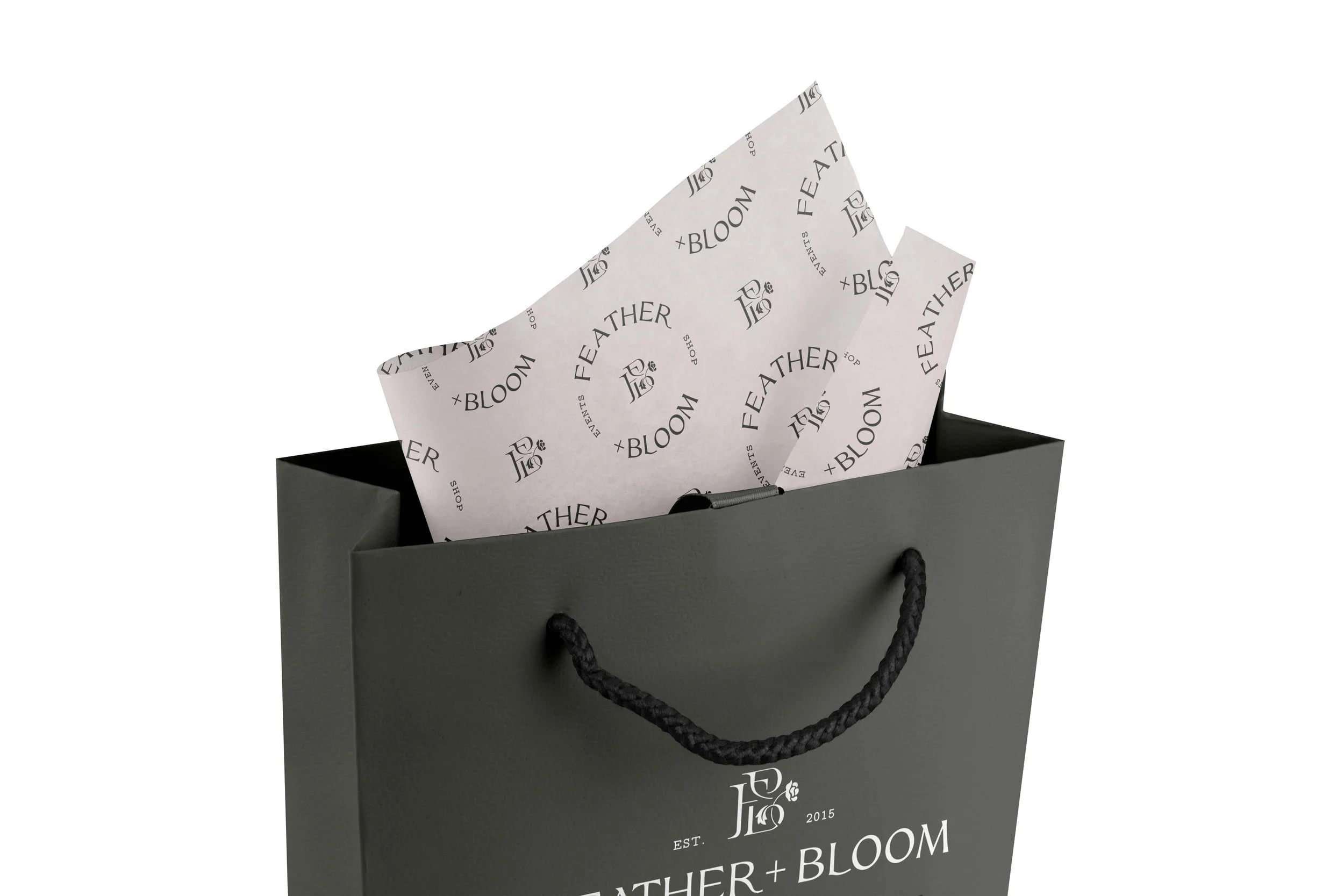 gift bag and wrapping paper printed with Feather + Bloom logos