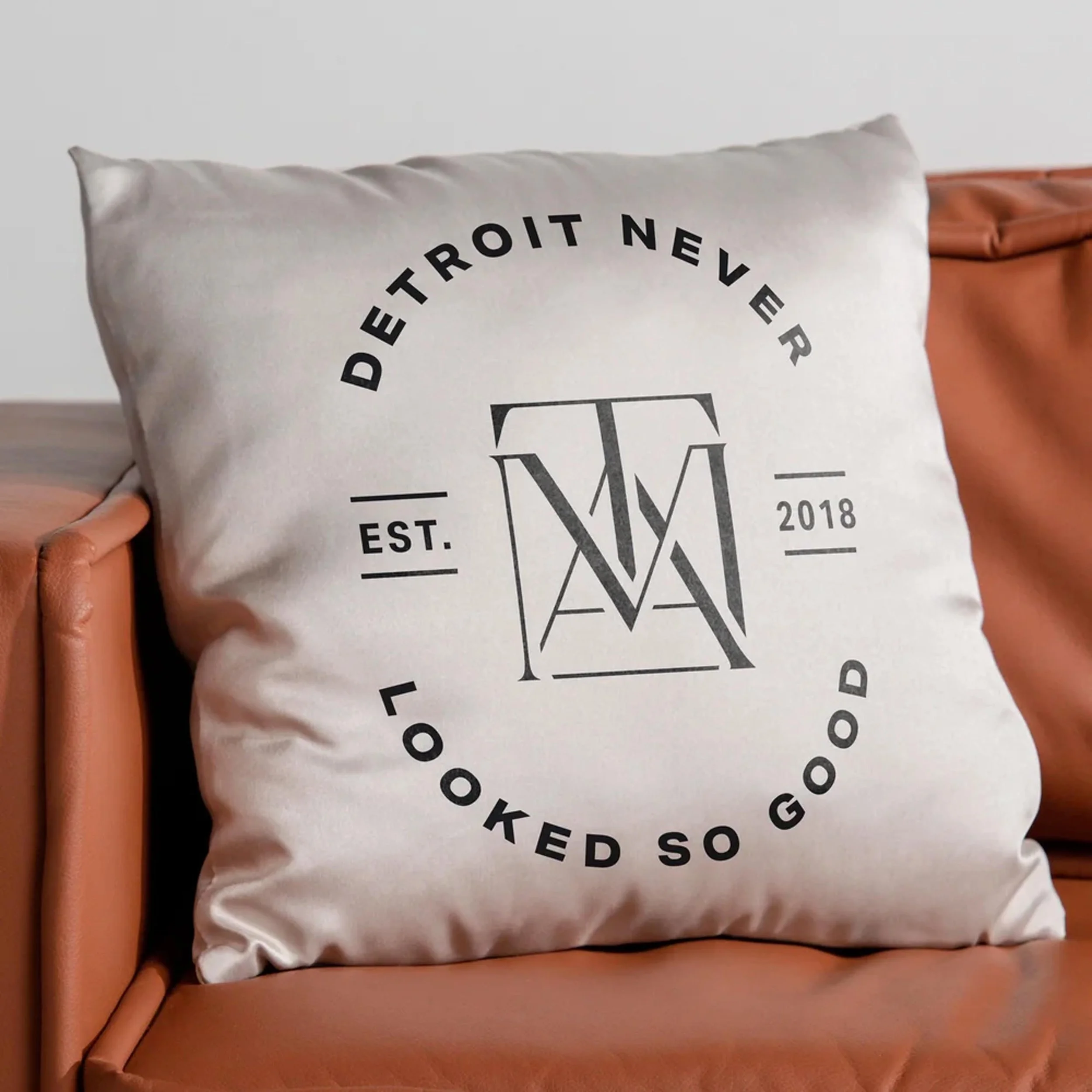 pillow printed with "Detroit never looked so good" badge