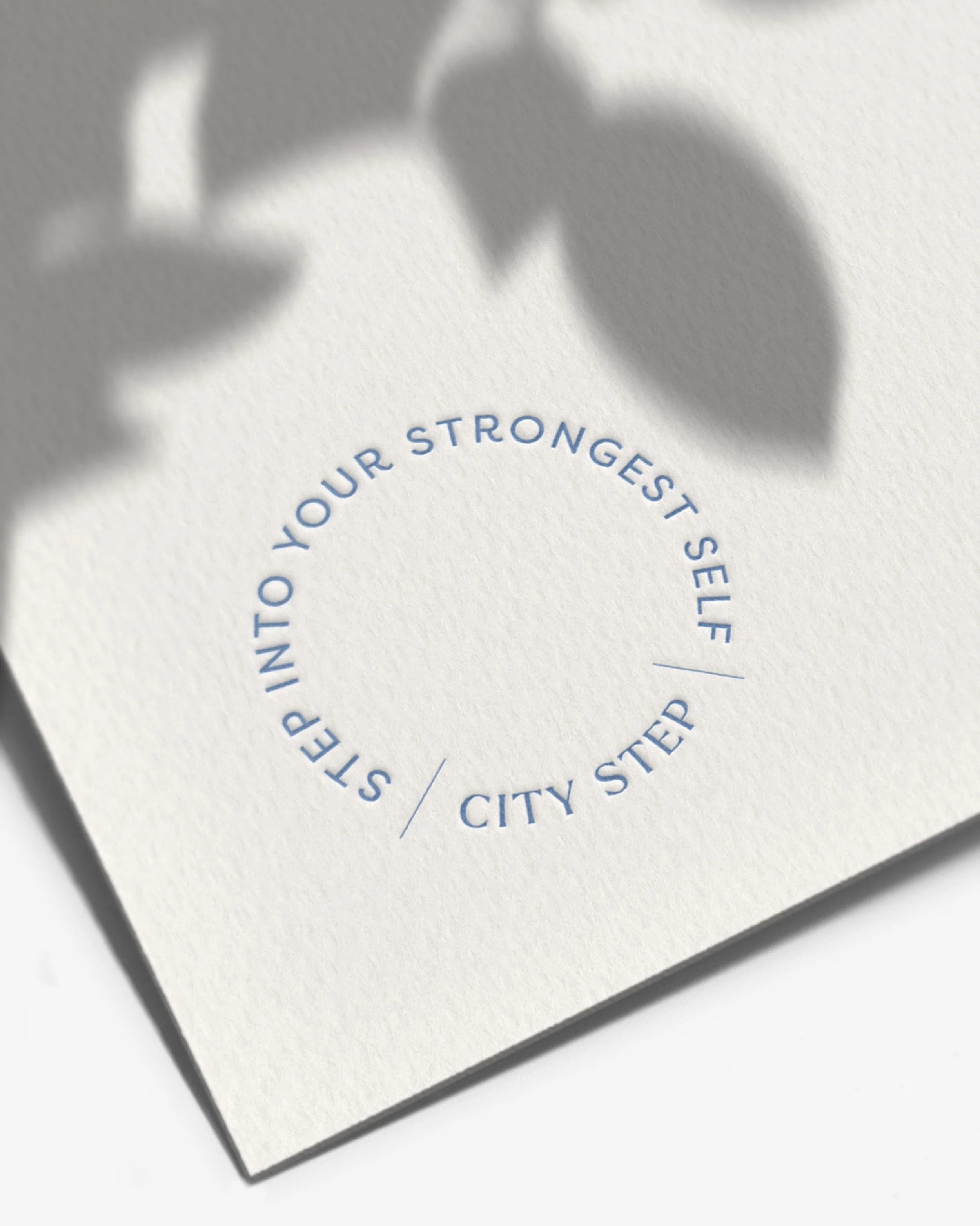 "Step into your strongest self" tagline embossed on stationery