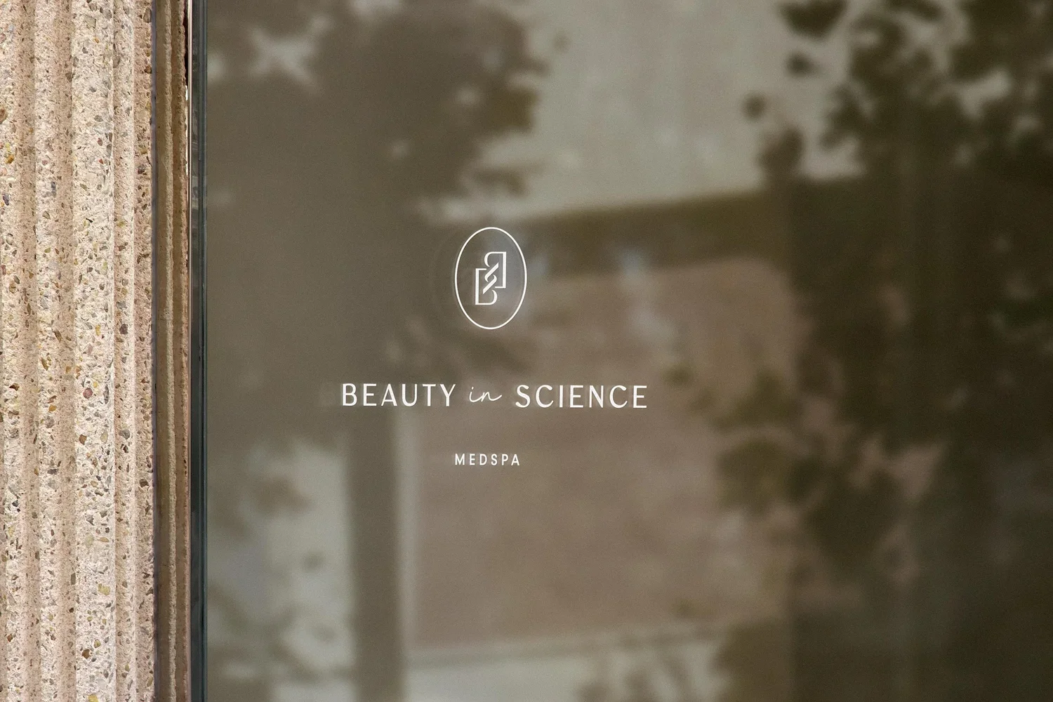 window signage featuring the Beauty in Science Medspa logo