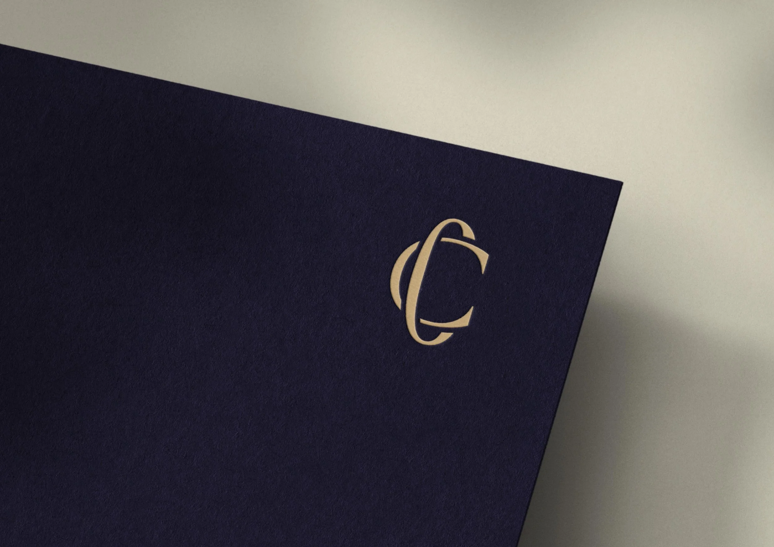 CC monogram embossed on navy cardstock
