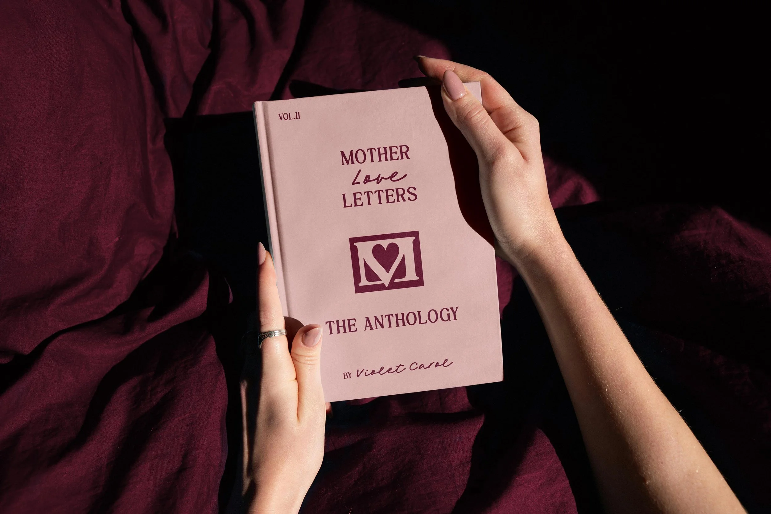 pink and burgundy book cover for "Mother Love Letters: The Anthology"