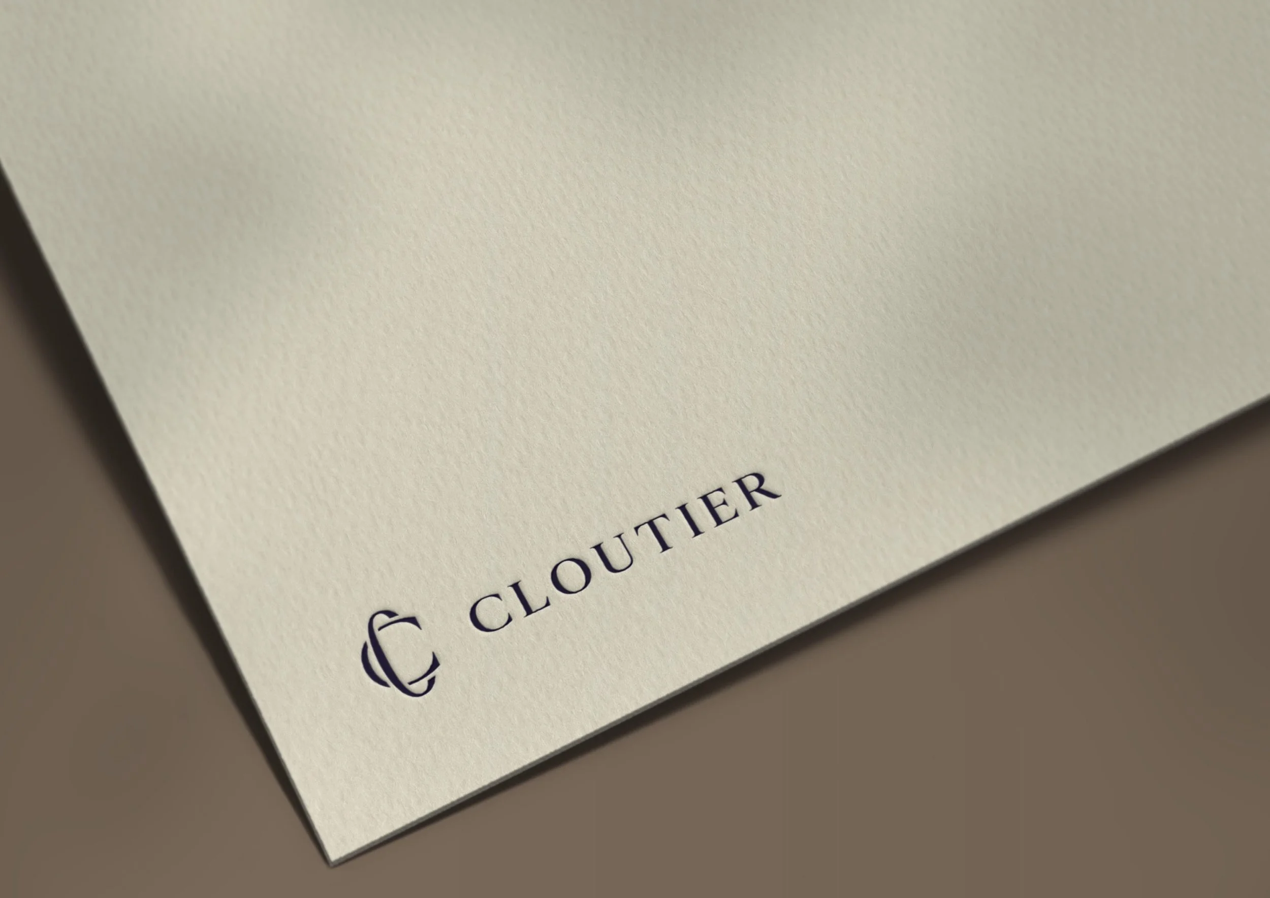 Cloutier & Co. logo embossed on cream cardstock