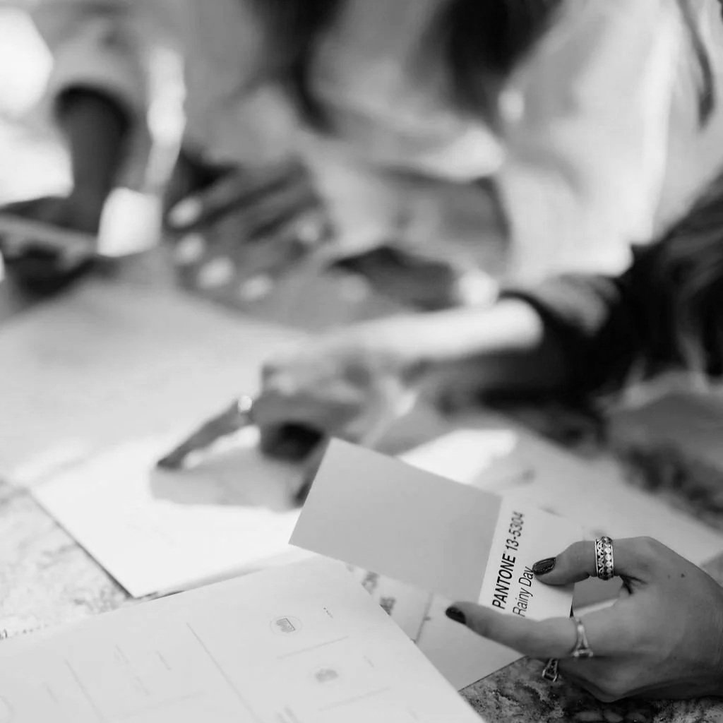 graphic designer pointing to a pantone swatch