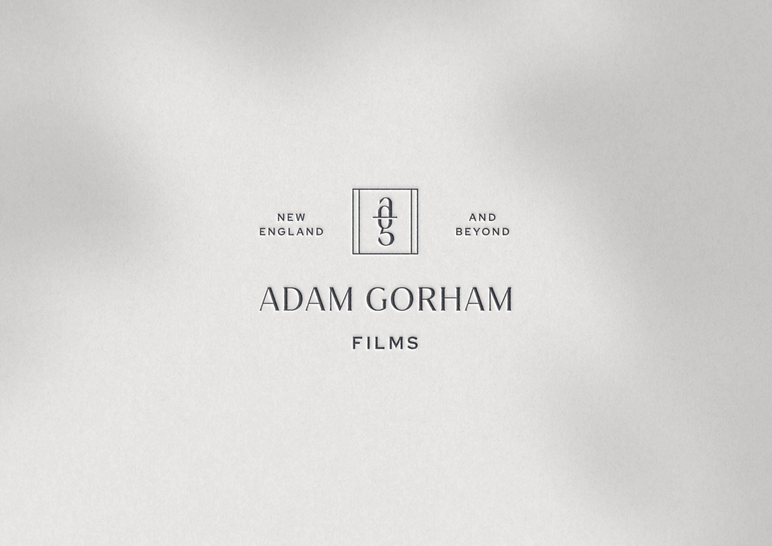 Adam Gorham Films logo embossed on white cardstock