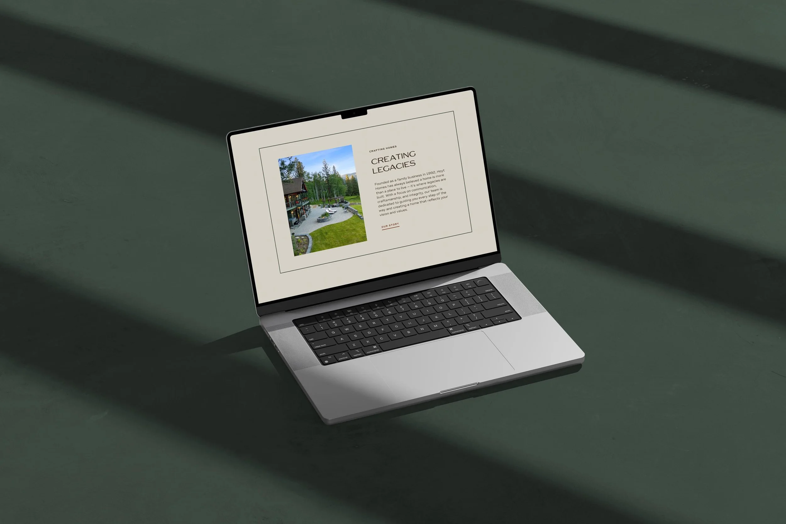 laptop displaying the Hoyt Homes website homepage about section with heading "Creating Legacies"