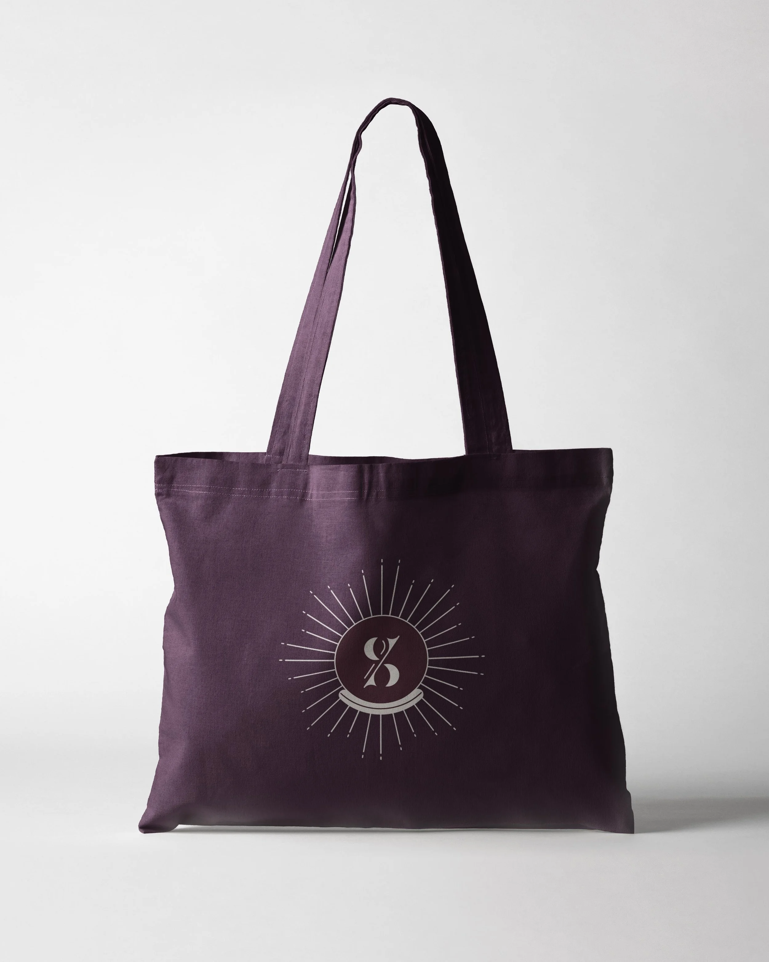 purple tote bag printed with Spellbound Events celestial graphic