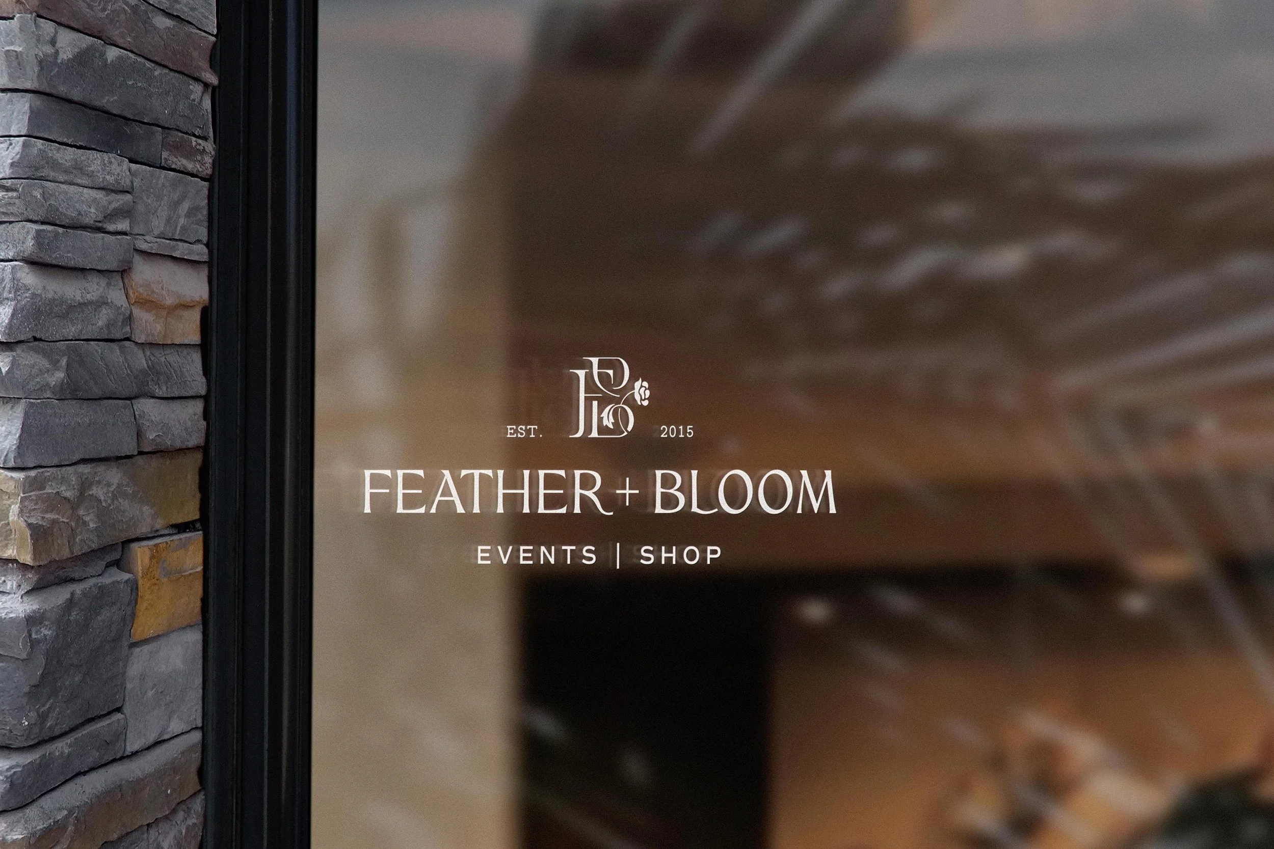 The Feather + Bloom shop's window sign
