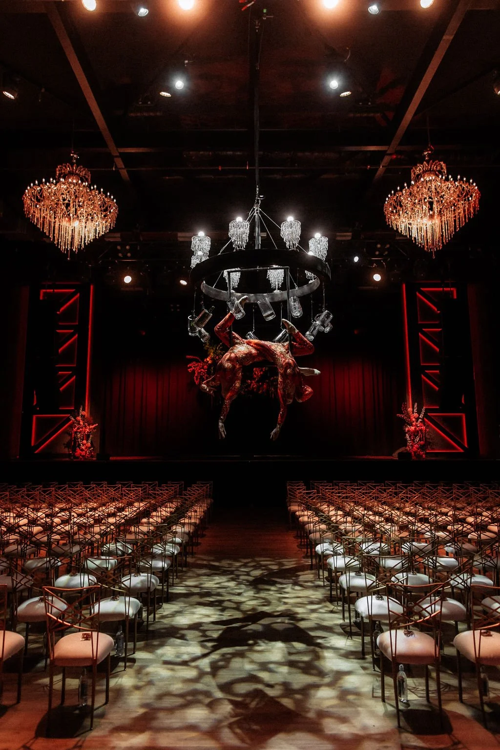 The Fillmore Theatre set for ceremony with Enticing Entertainment artists handing from a chandelier to pour champagne