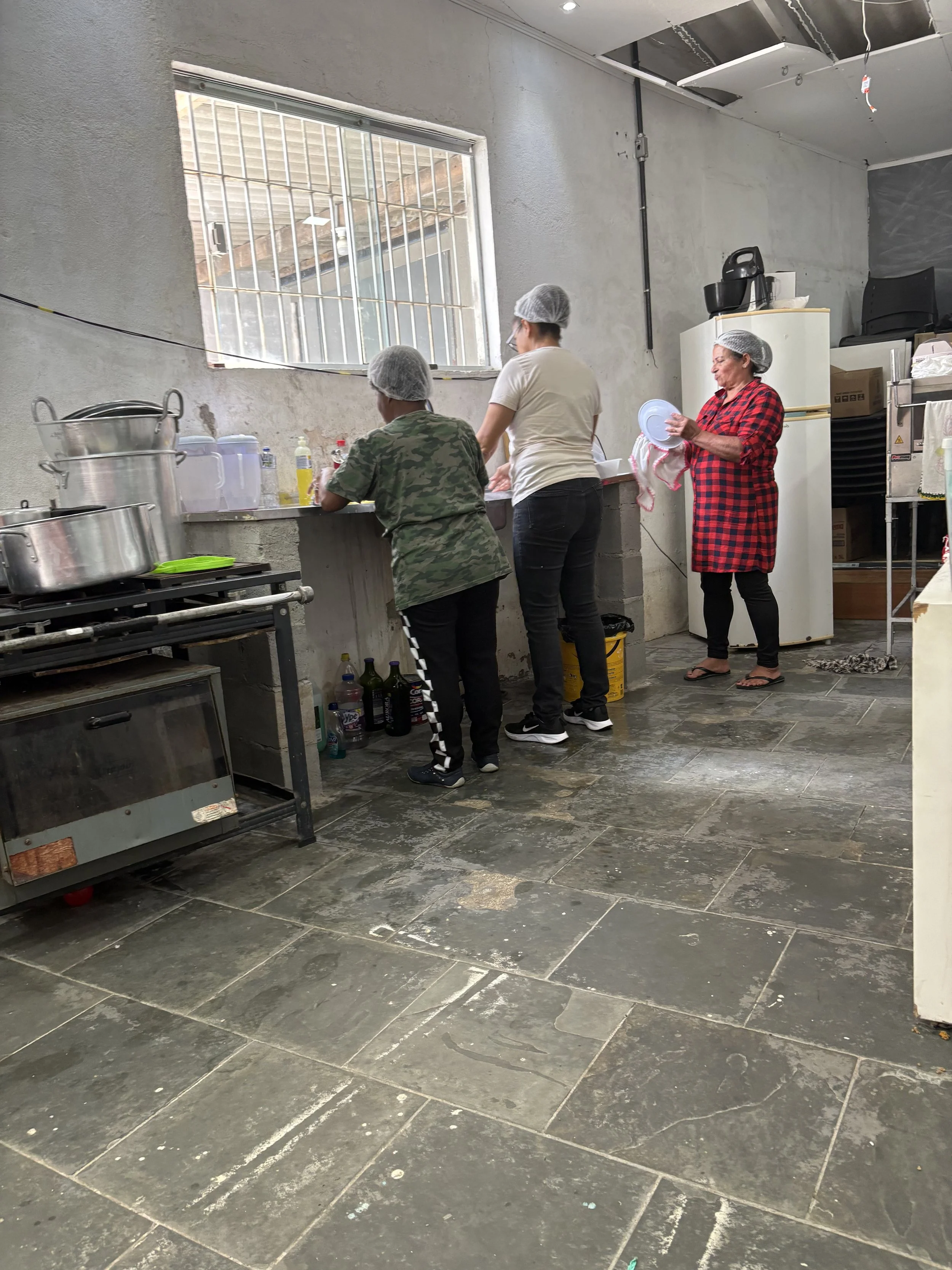 Food prep in Sao Palo (Brazil), serving hungry children with nourishing food and a big dose of love.