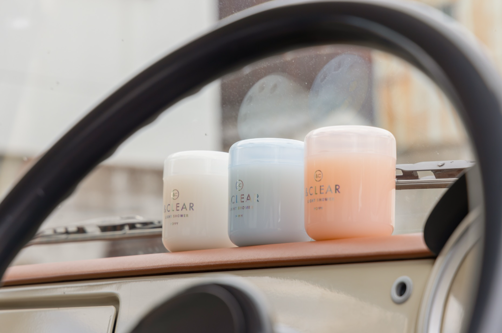 Three &Clear Light Shower air fresheners inside a vehicle, behind the steering wheel.