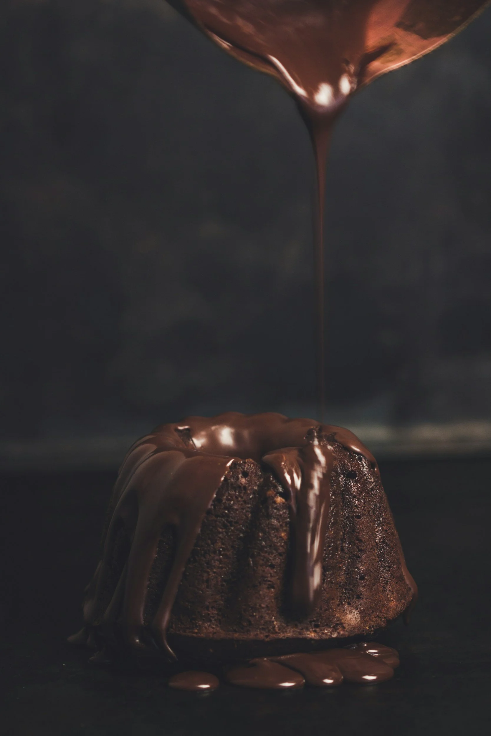 A chocolate lava cake with melted chocolate cascading down the sides.